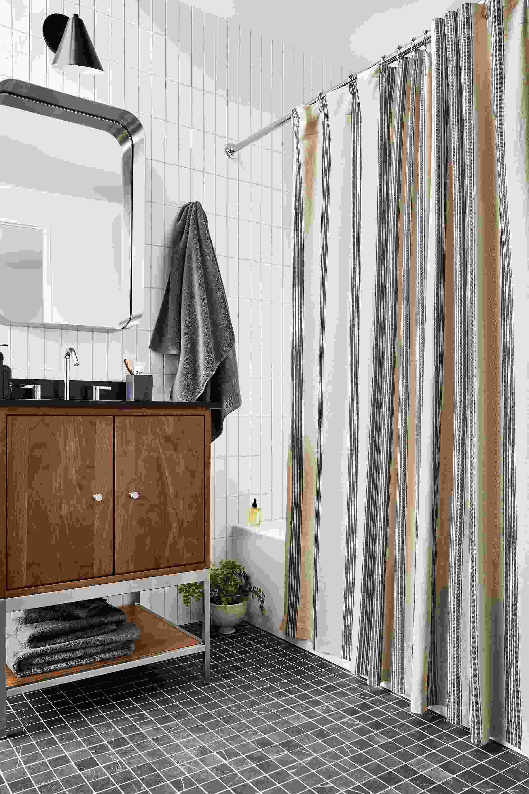 Bathroom with Linear 26-wide walnut vanity and Cameron shower curtain in Natural and Black stripes.
