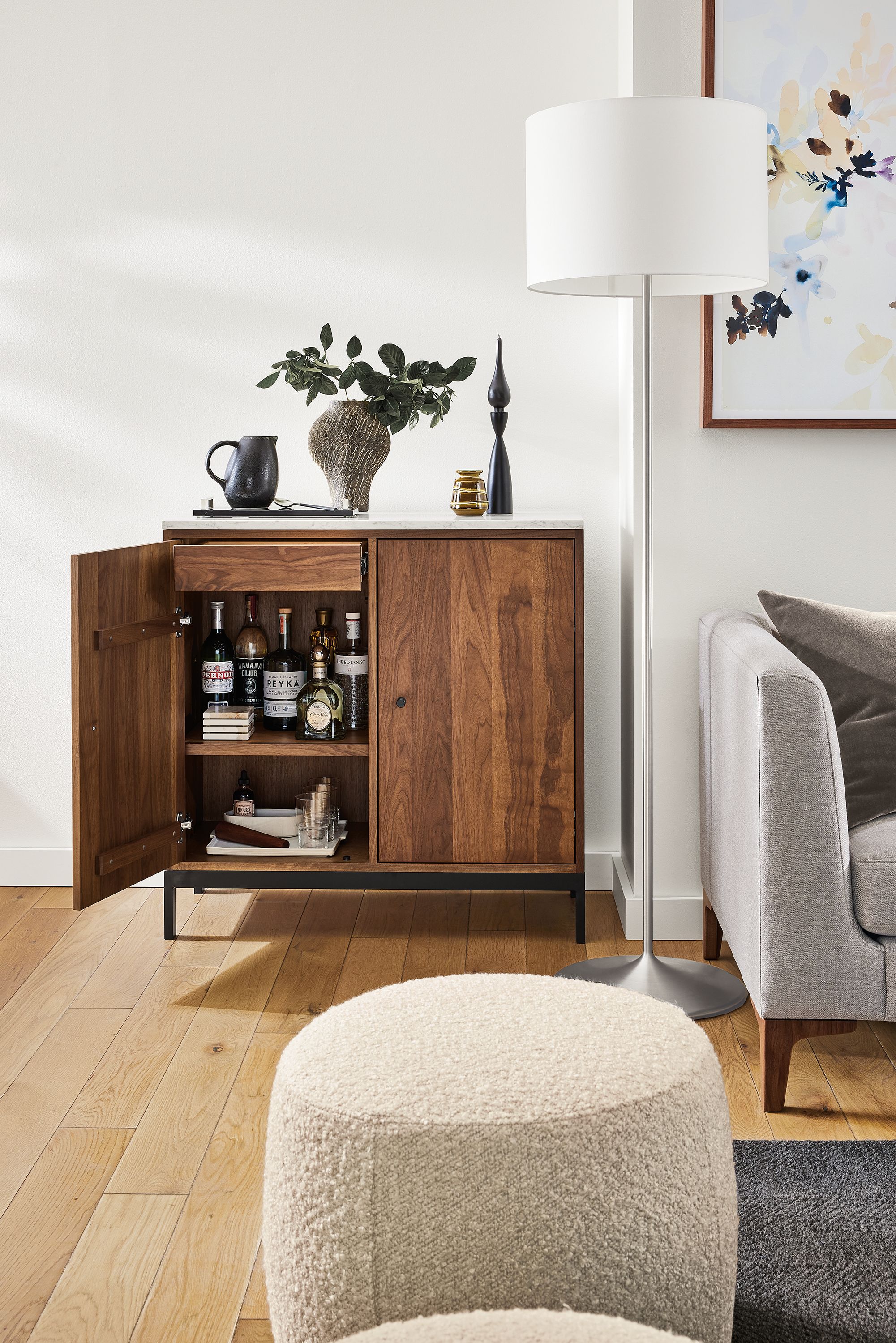 Living area with Linear 36-wide storage cabinet in walnut with quartz top with door open.