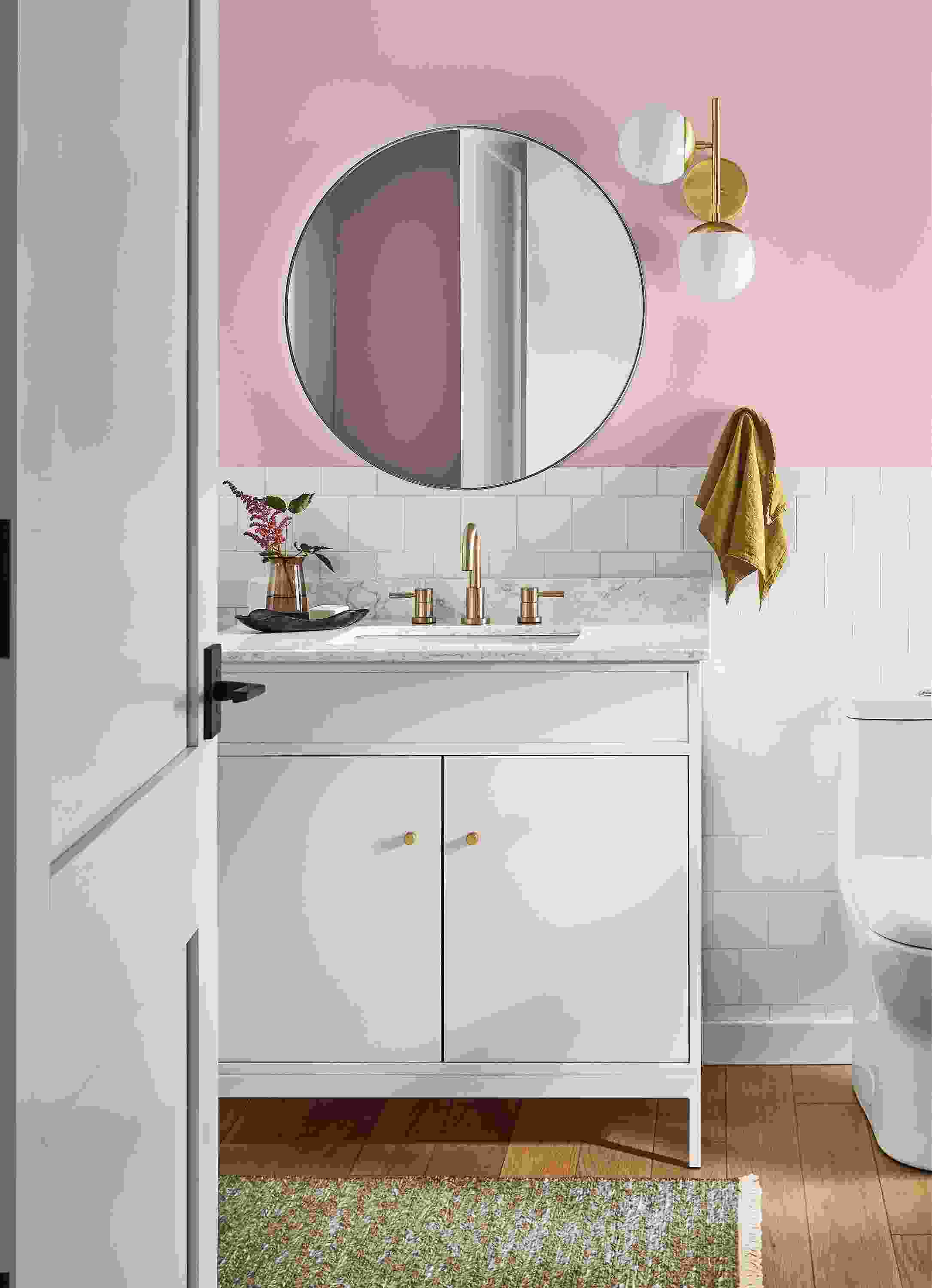 bathroom with linear bathroom vanity in white, infinity round wall mirror, pearl sconce.