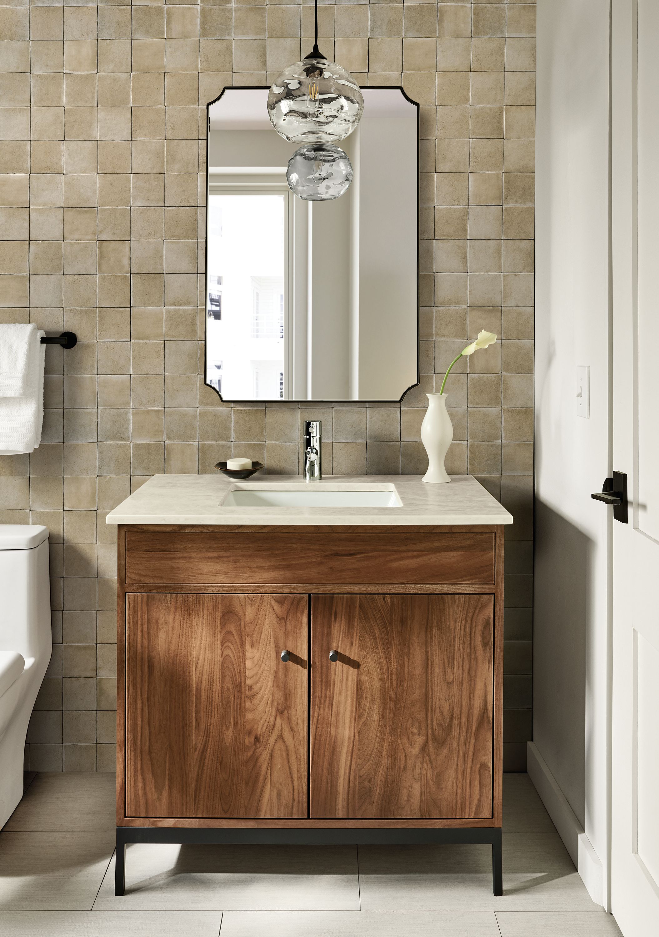 Bathroom with Linear single-sink vanity in walnut with Mahal Quartz top and Collette wall mirror in graphite.