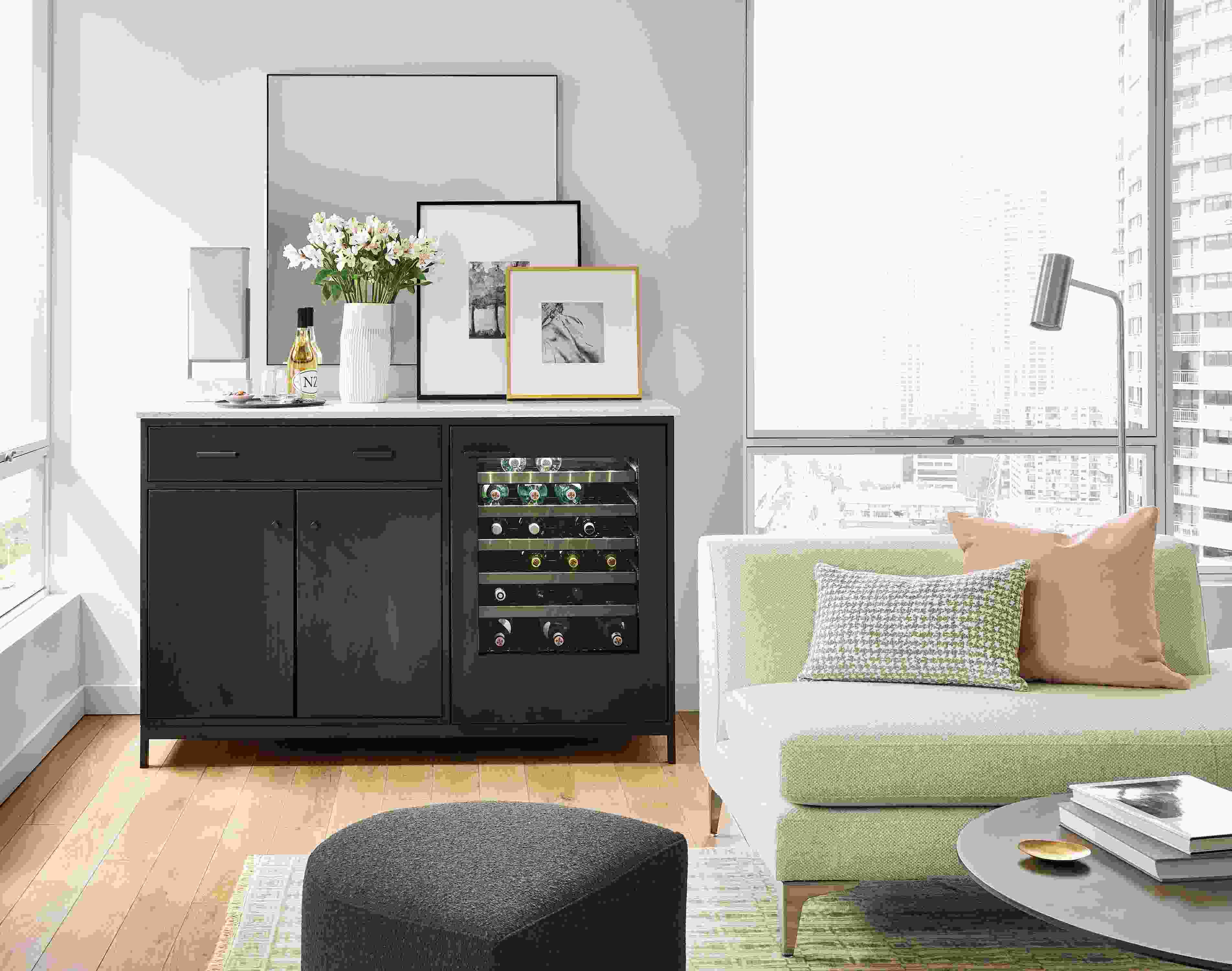 living room with linear bar cabinet with refrigeration, sterling left-back sofa, silva ottoman.