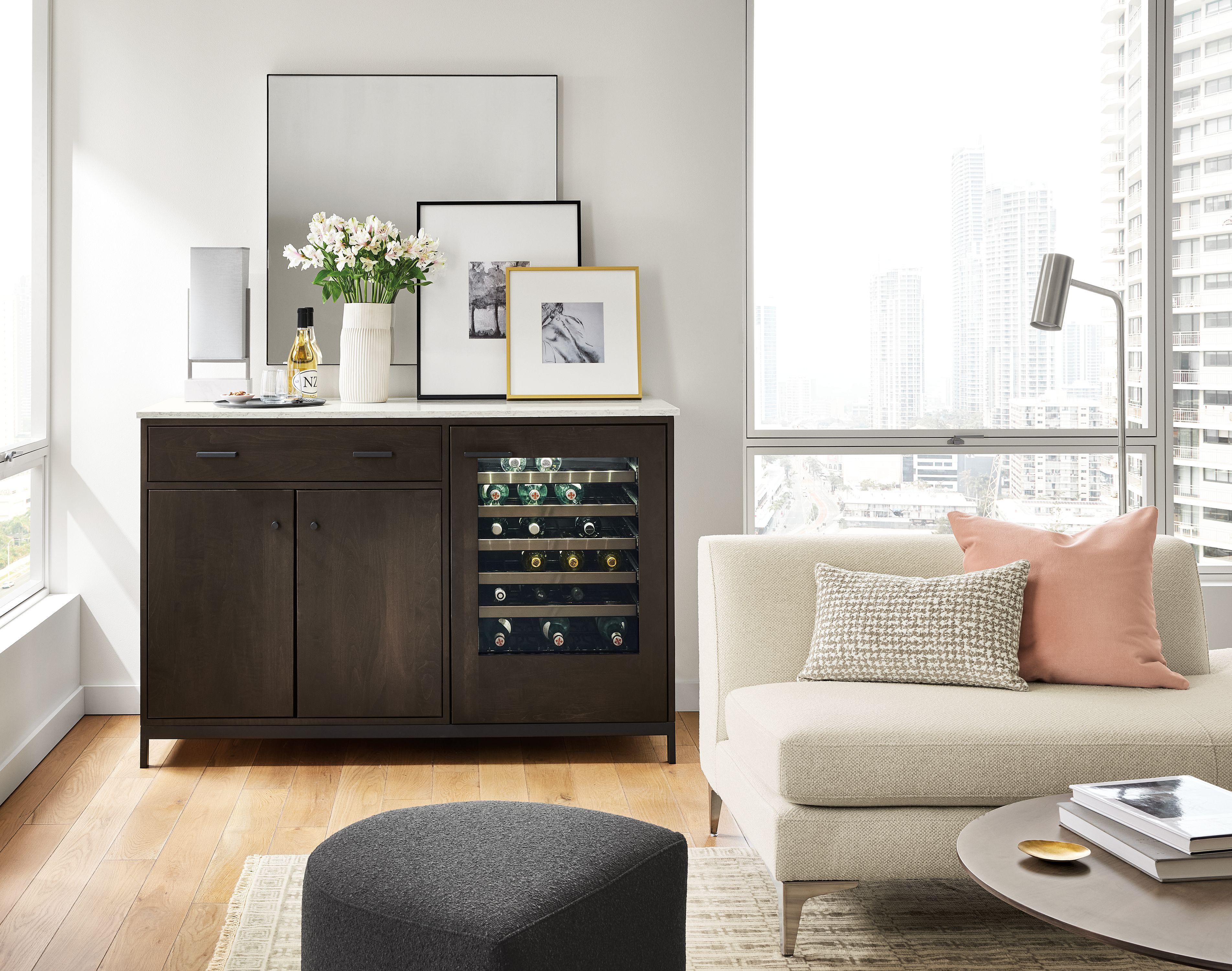 living room with linear bar cabinet with refrigeration, sterling left-back sofa, silva ottoman.