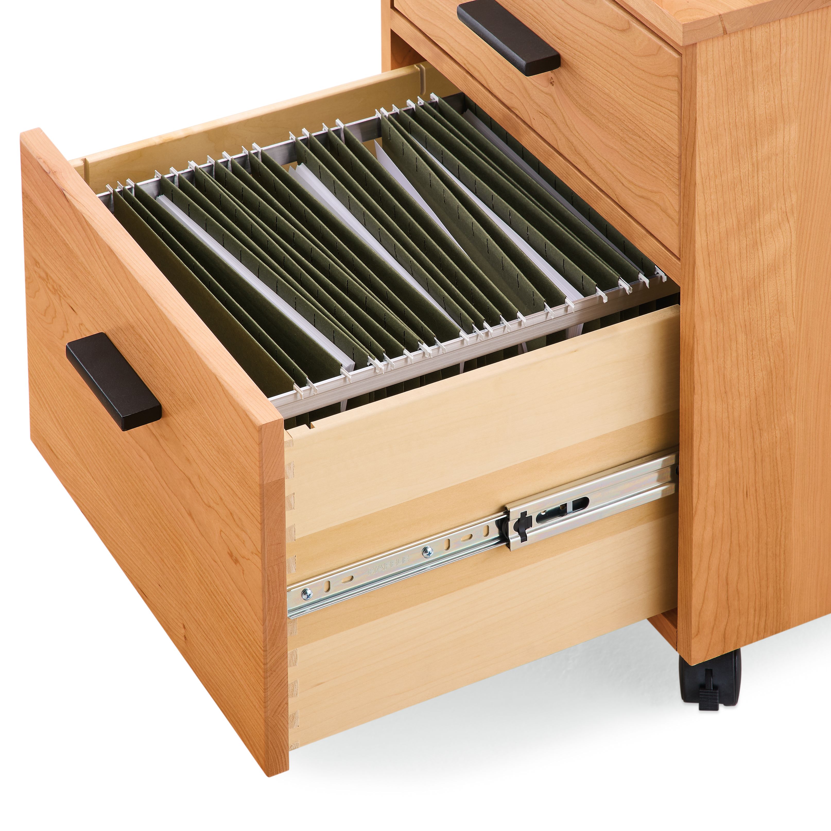 Detail of open drawer on Linear rolling file cabinet in cherry showing letter size file folders.