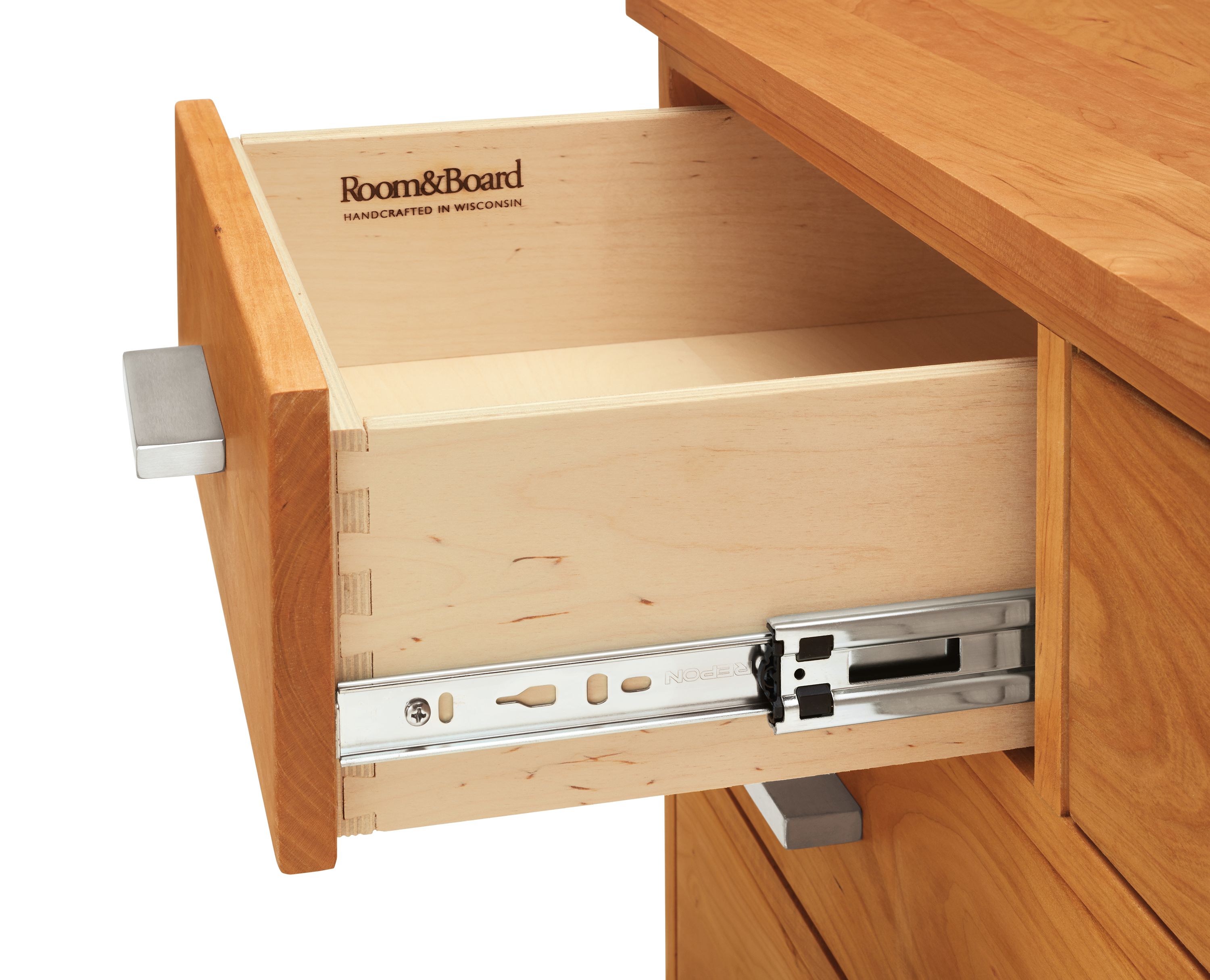 Detail of Linear 36-wide Six-Drawer Dresser in Cherry and Stainless Steel.