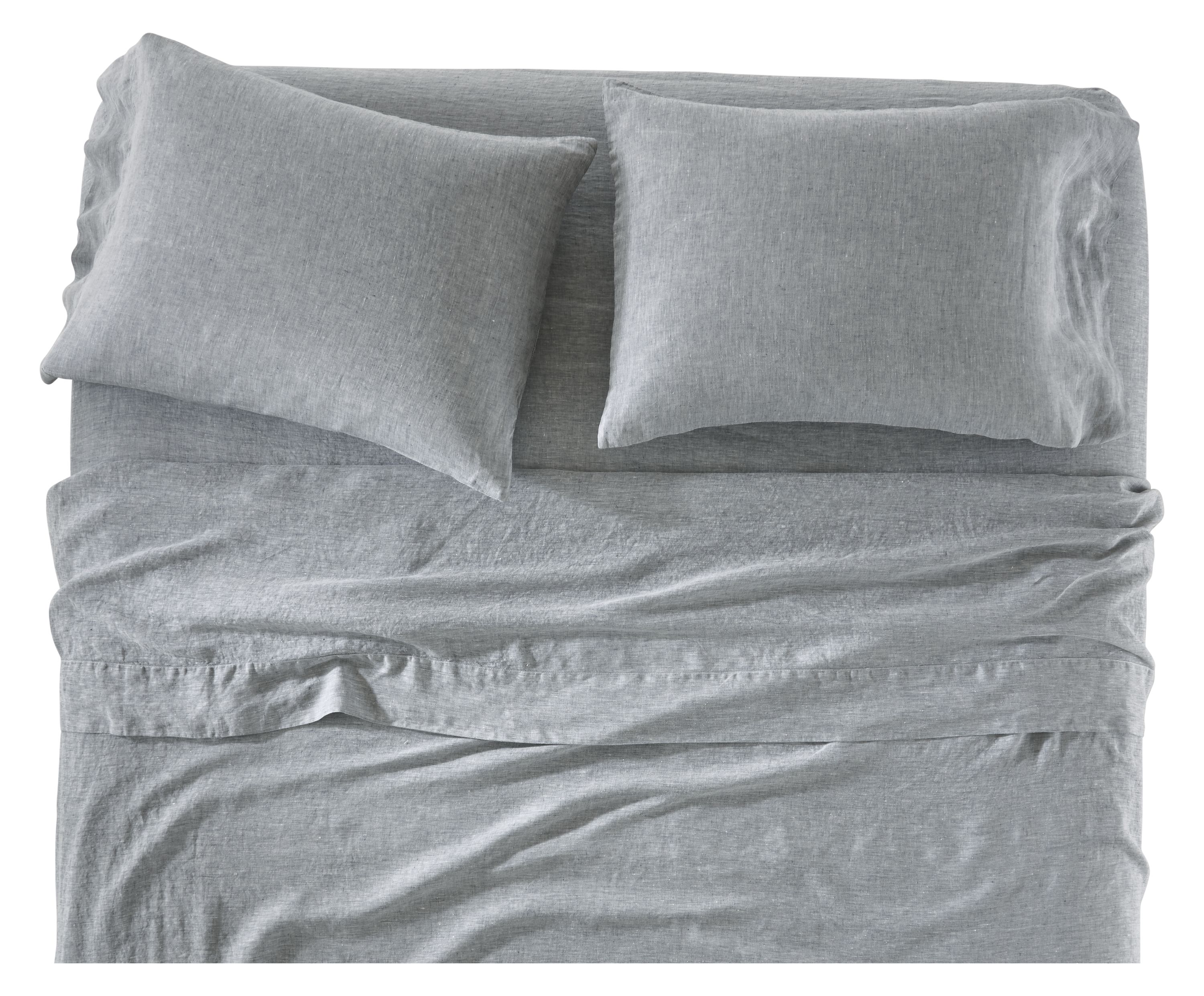 Front of relaxed linen sheet set in blue chambray on bed.