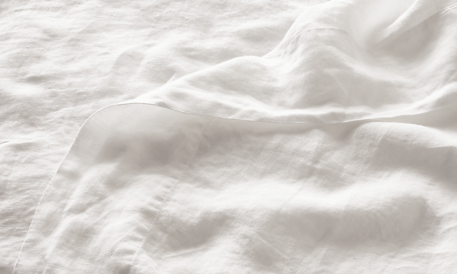 Detail of Relaxed Linen Queen Flat Sheet in White.