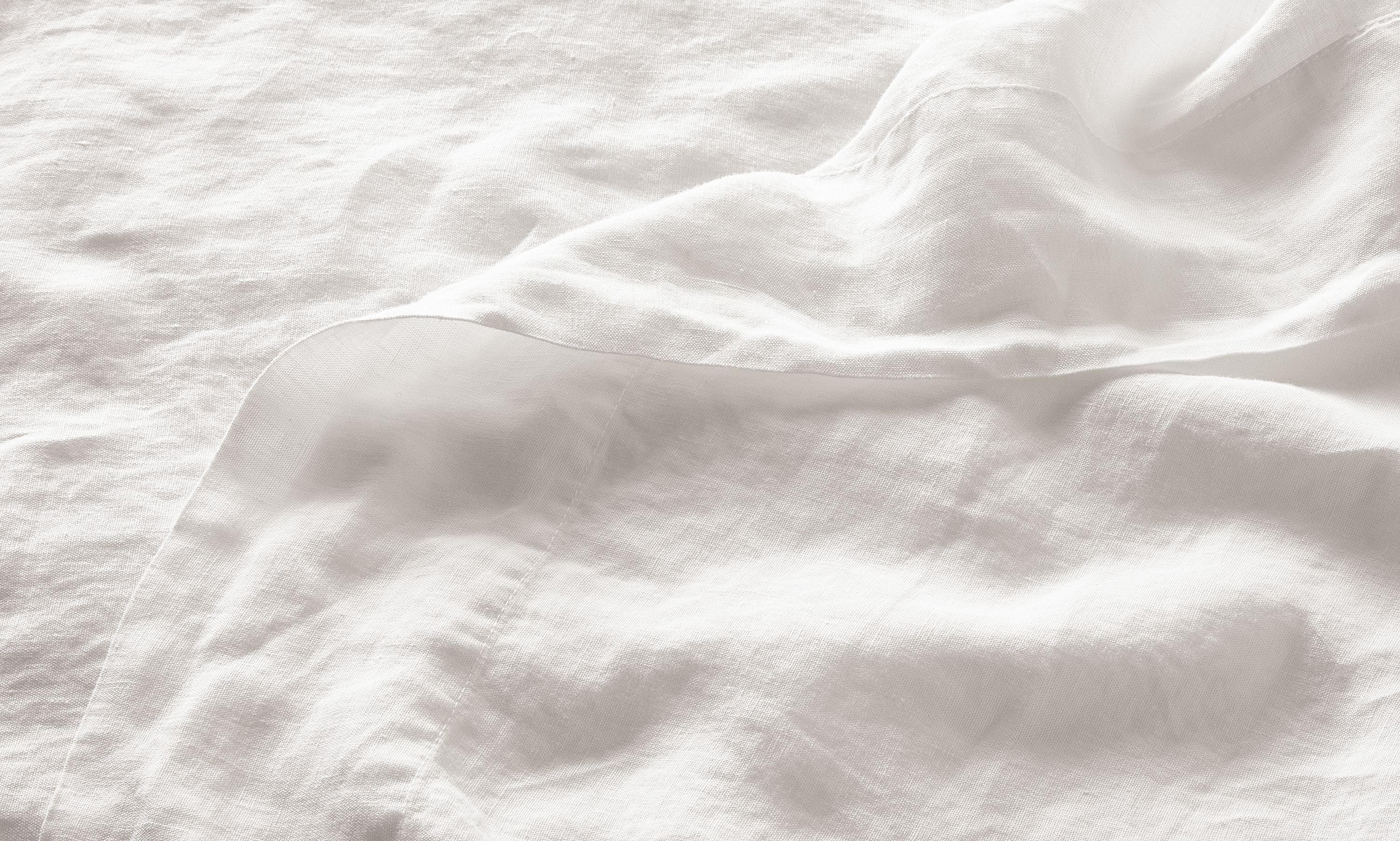 Detail of Relaxed Linen Queen Flat Sheet in White.