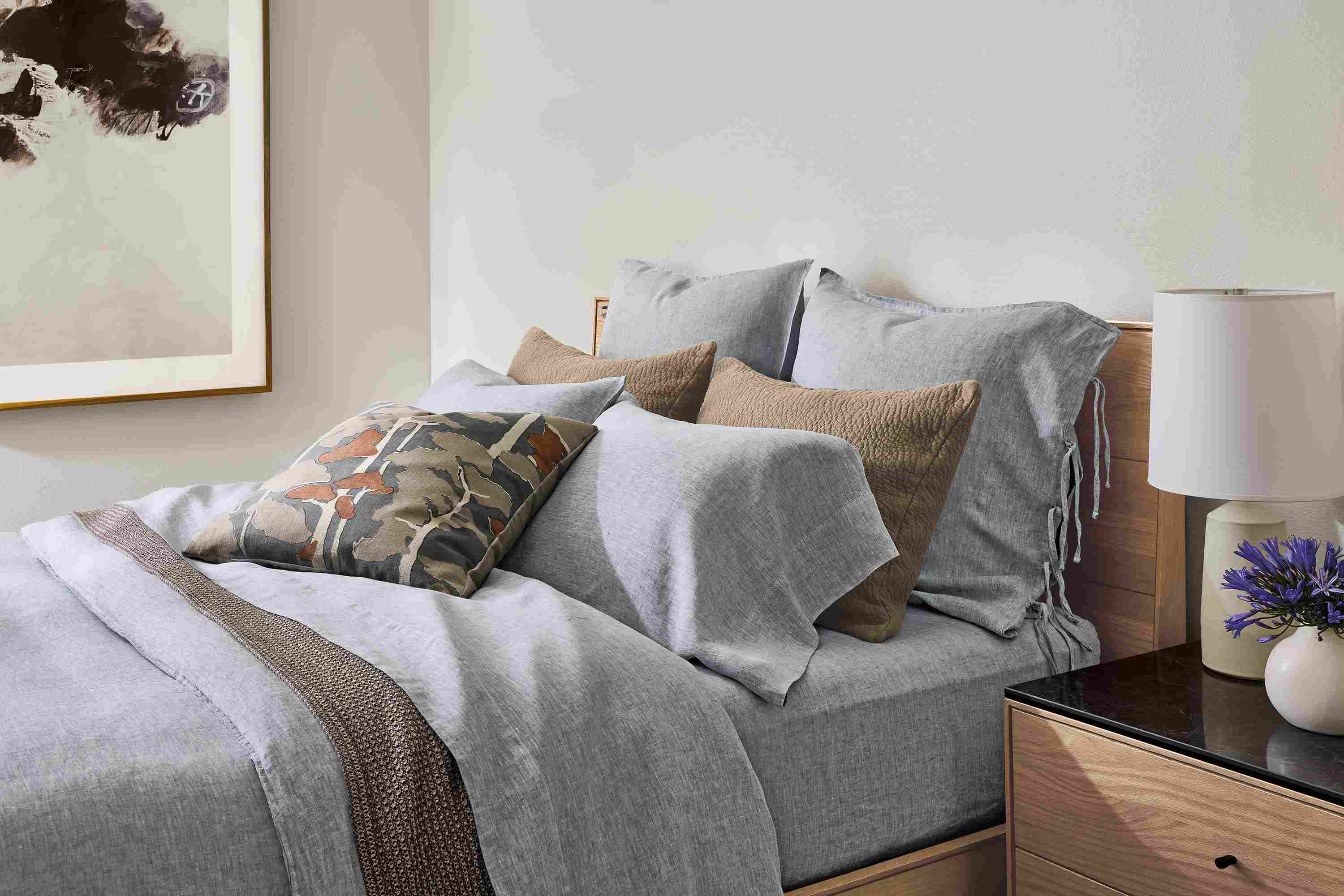 Bedroom with Hudson queen storage bed, relaxed linen duvet cover in blue chambray and Morgan blanket in earth.