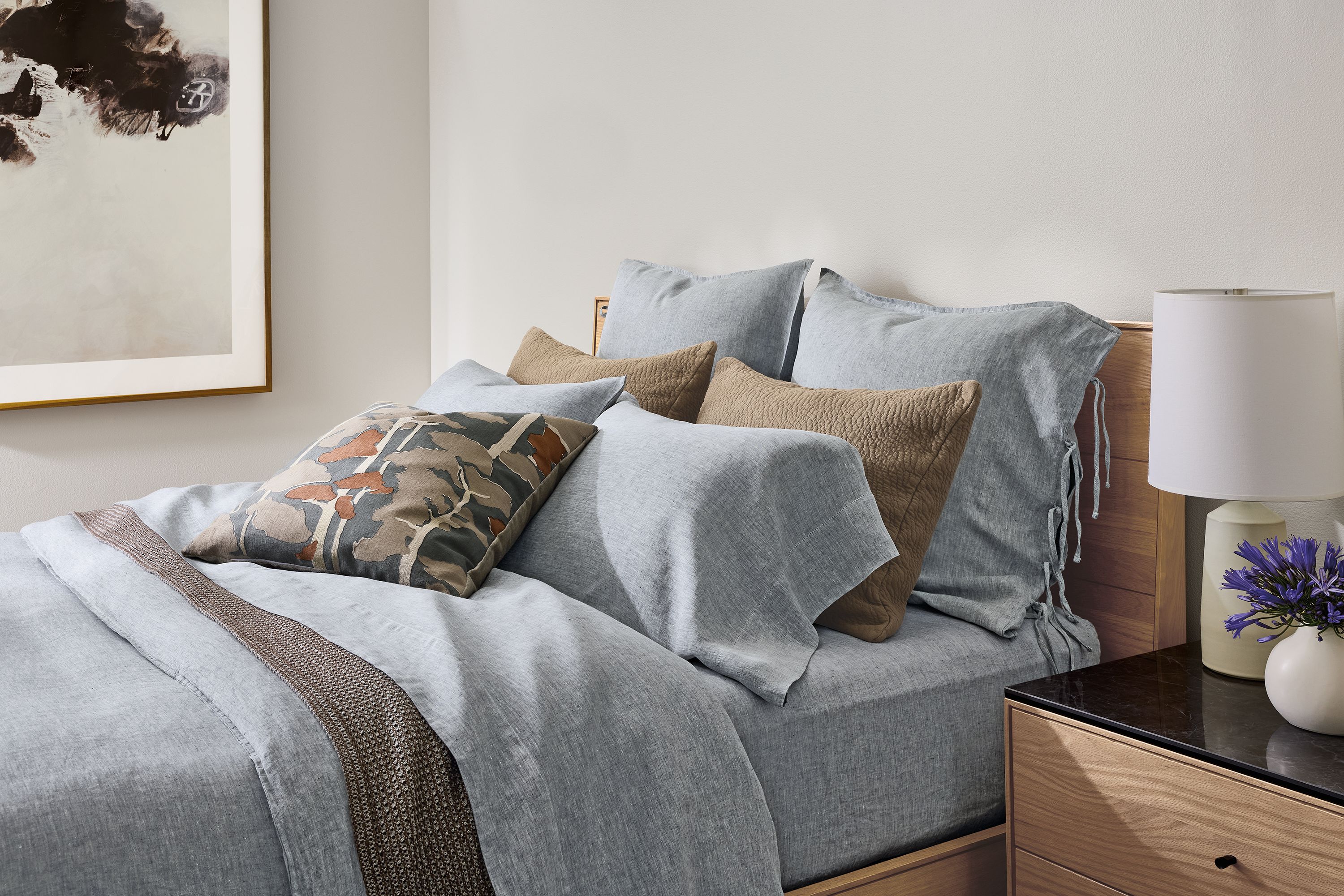 Bedroom with Hudson queen storage bed, relaxed linen duvet cover in blue chambray and Morgan blanket in earth.