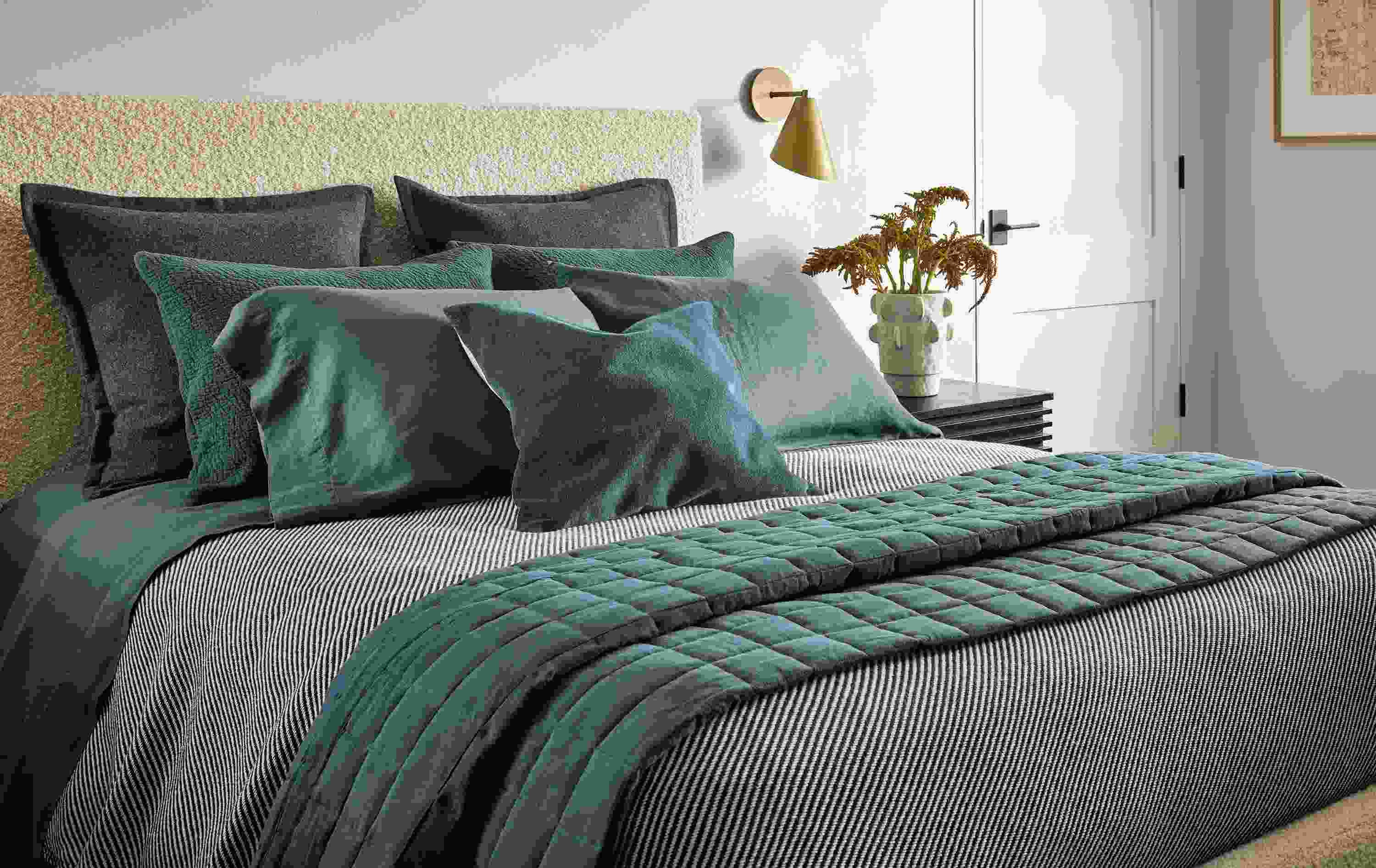 Bedroom with relaxed linen quilted coverlet in dark slate, finchley blanket in black/ivory and washable wool sham in charcoal.