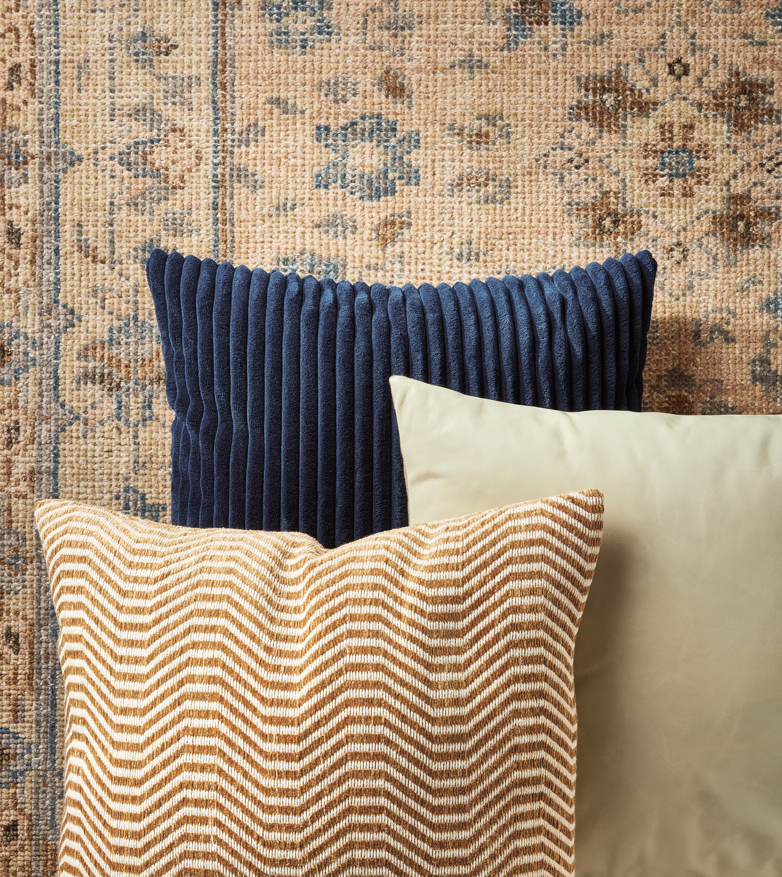 Collage of Veda Rug in Camel with complimenting throw pillows.