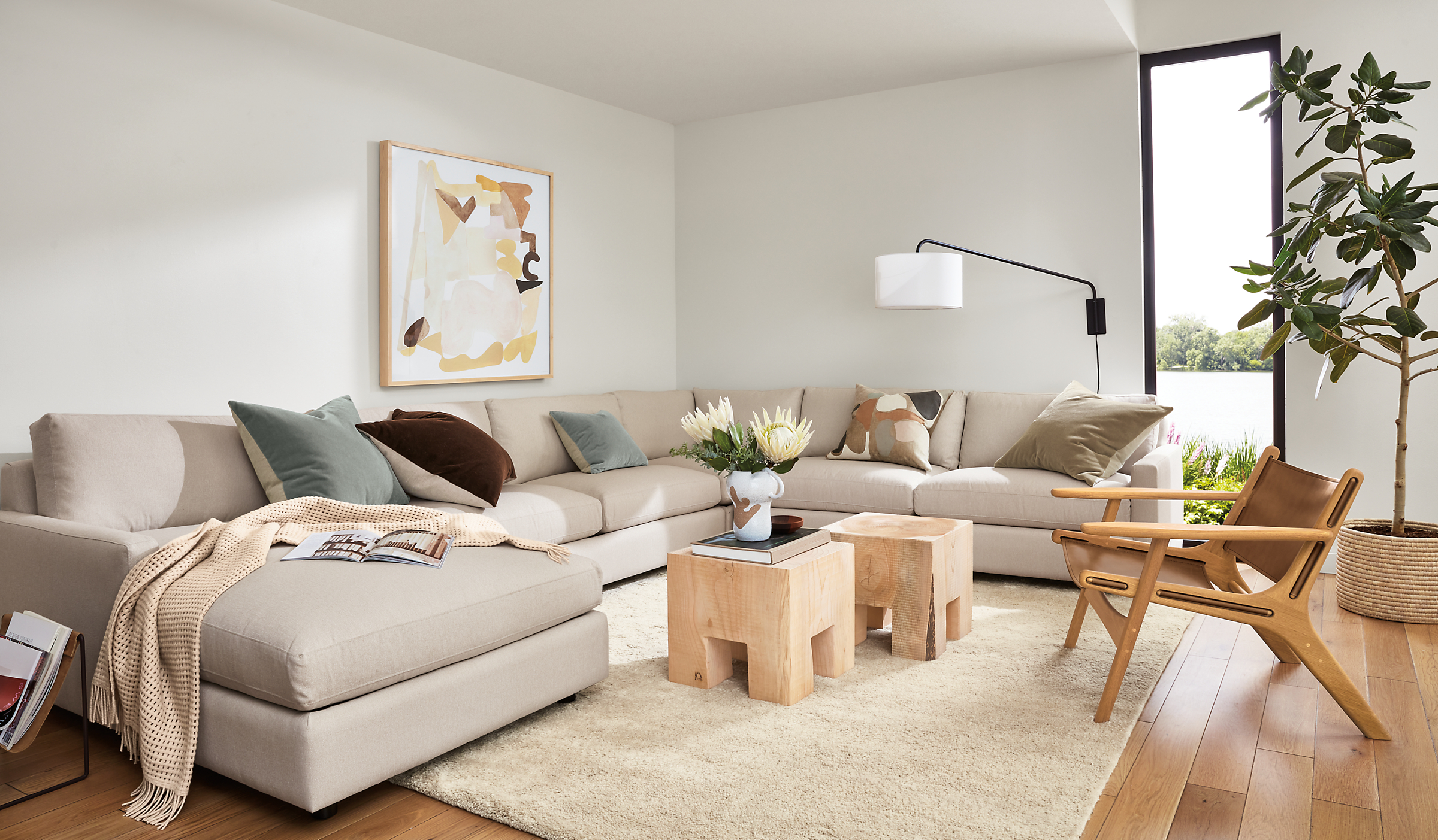 living room with linger sectional, cedro cubes, lars lounge chair, jen garrido wall art.