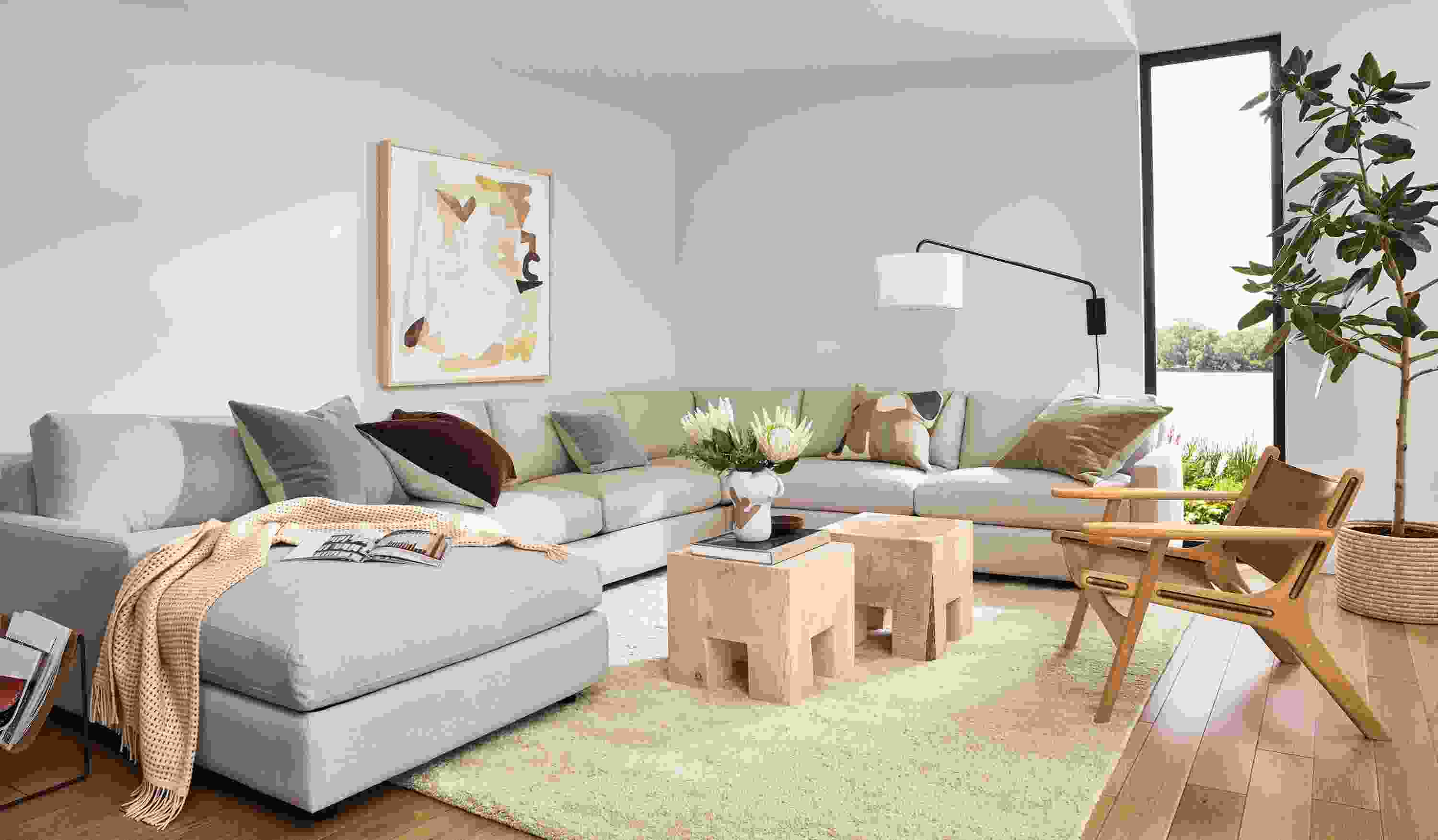 living room with linger sectional, cedro cubes, lars lounge chair, jen garrido wall art.