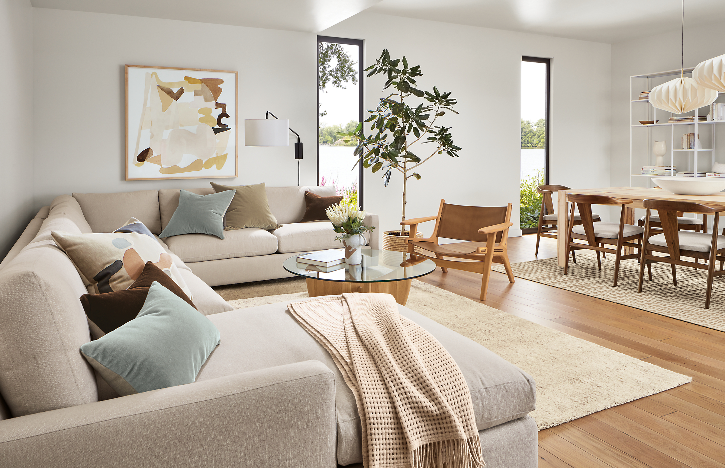 living room with linger sectional, lars lounge chair, jen garrido artwork.