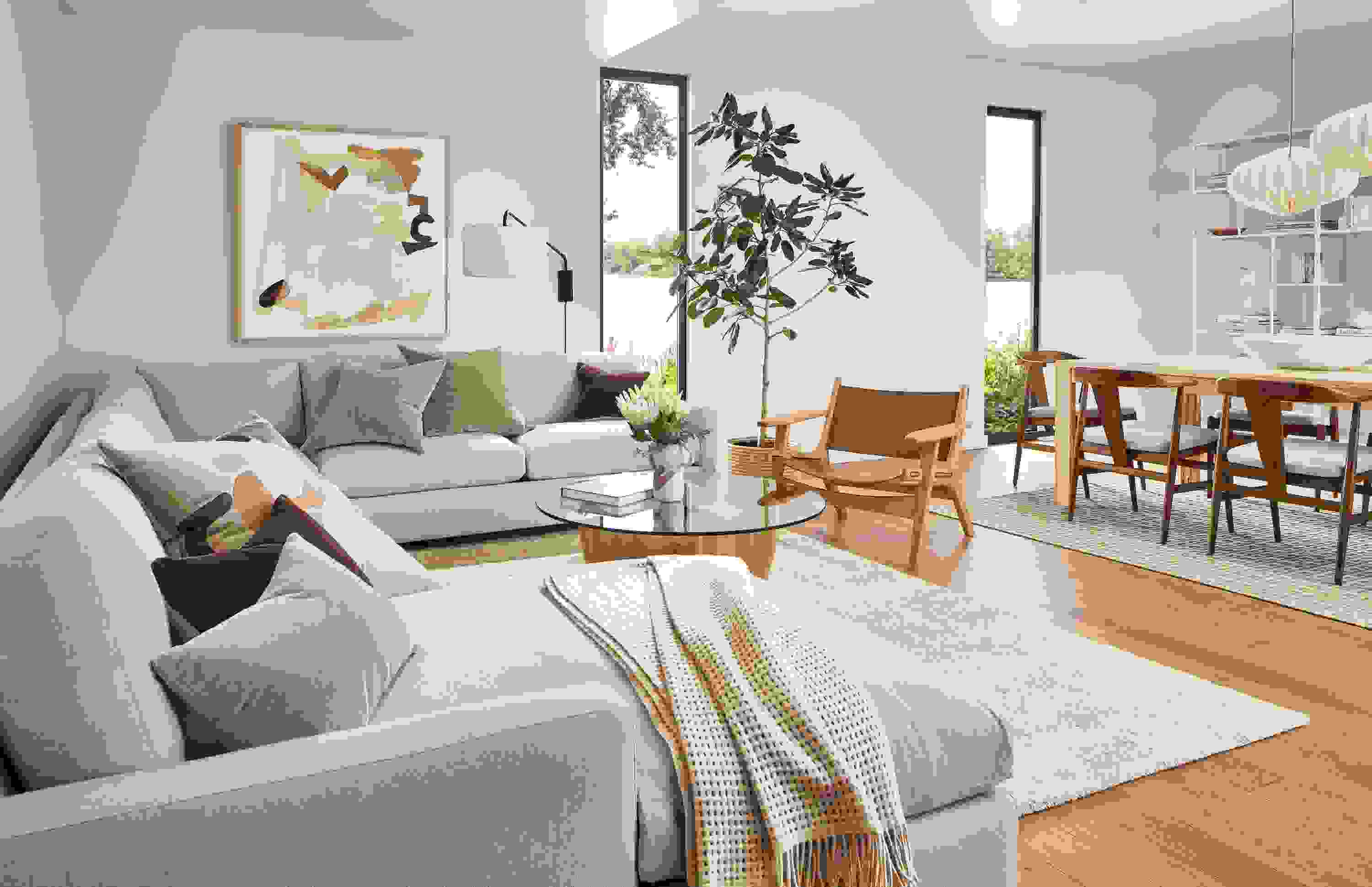 living room with linger sectional, lars lounge chair, jen garrido artwork.