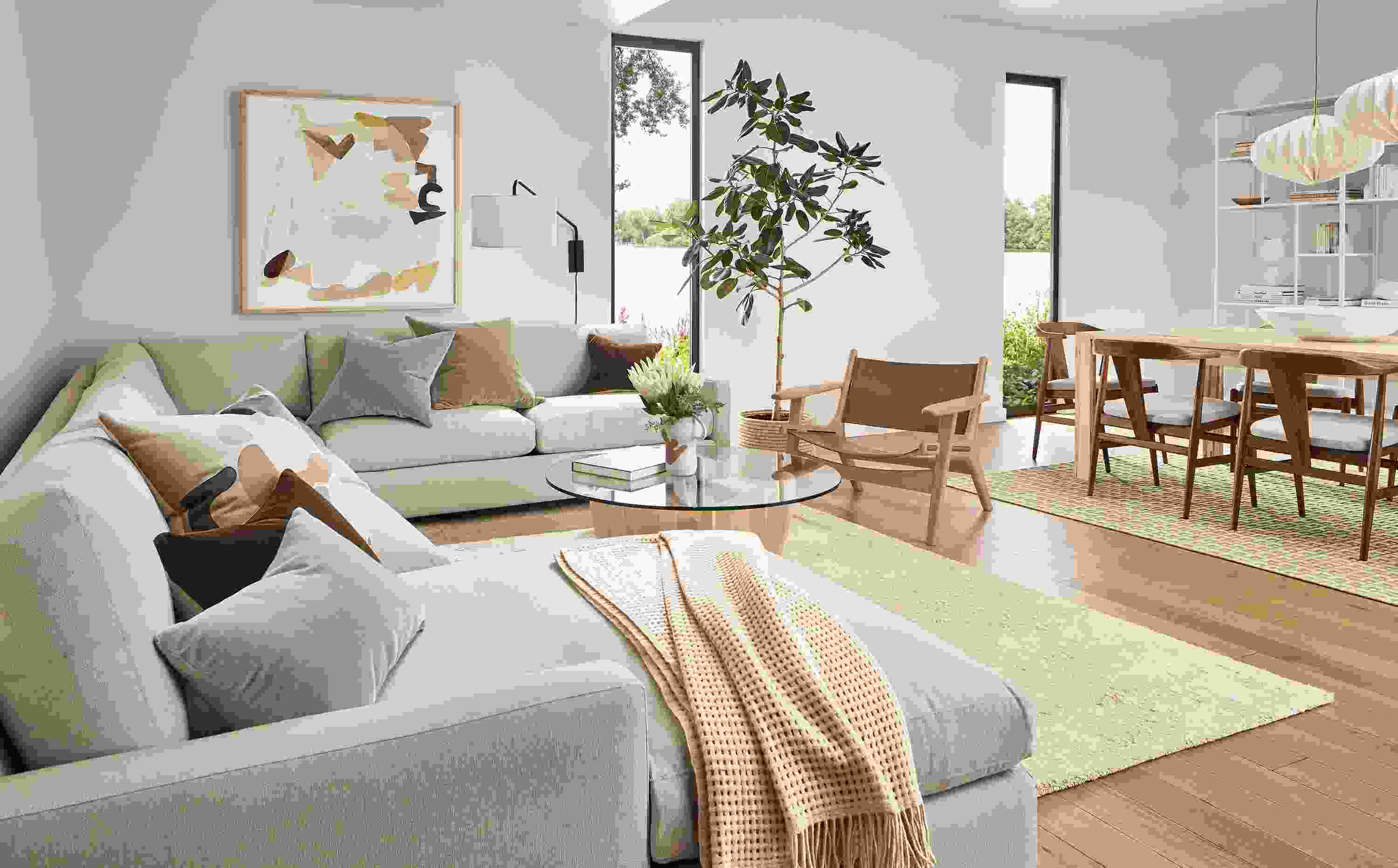 Living room with linger sectional, lars lounge chair in rye on red oak and sellare cognac leather, sanders table in salt and Jen Garrido artwork.