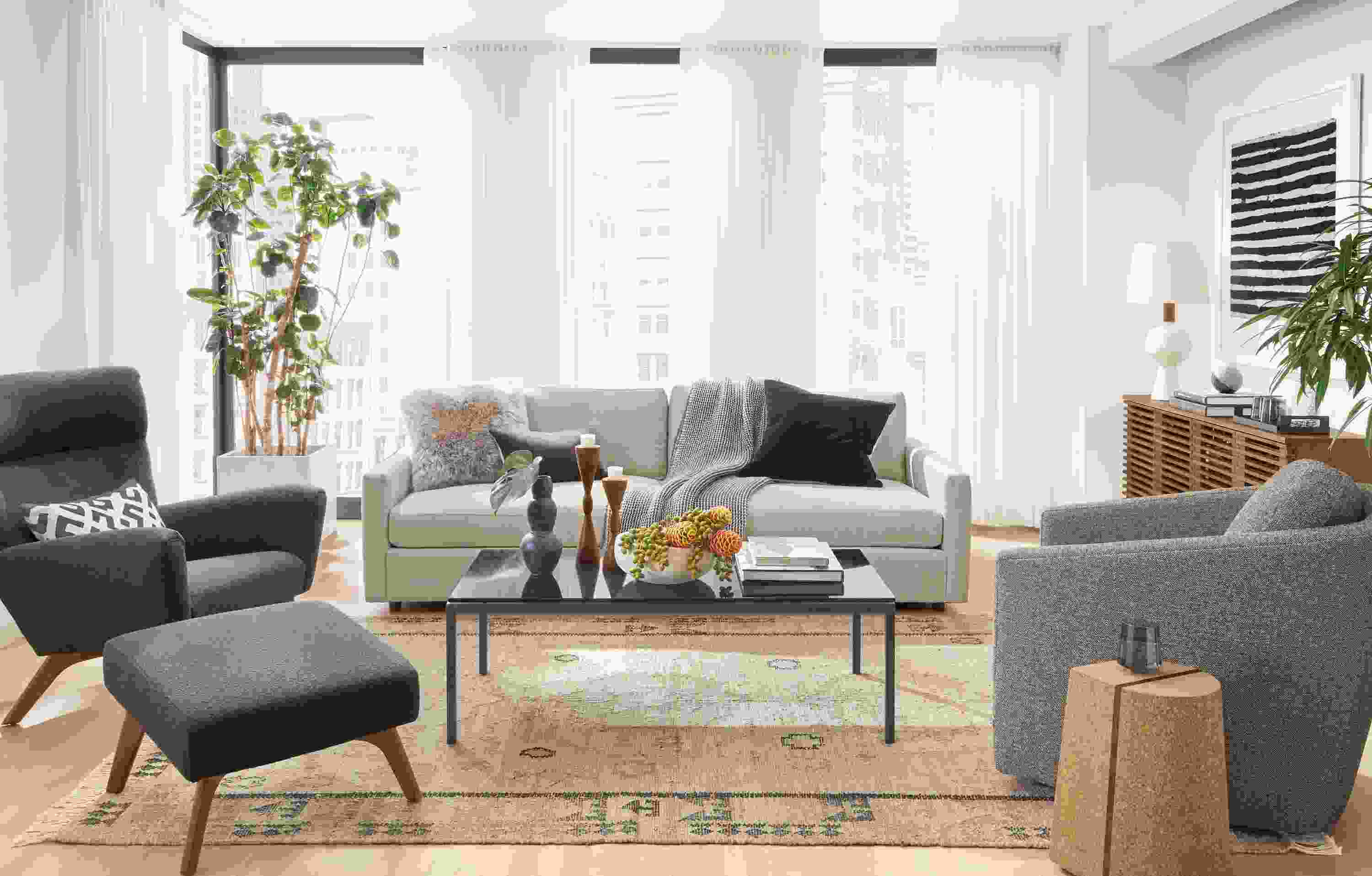 Detail of Linger sofa in Hines Oatmeal fabric in living room with vintage rug.