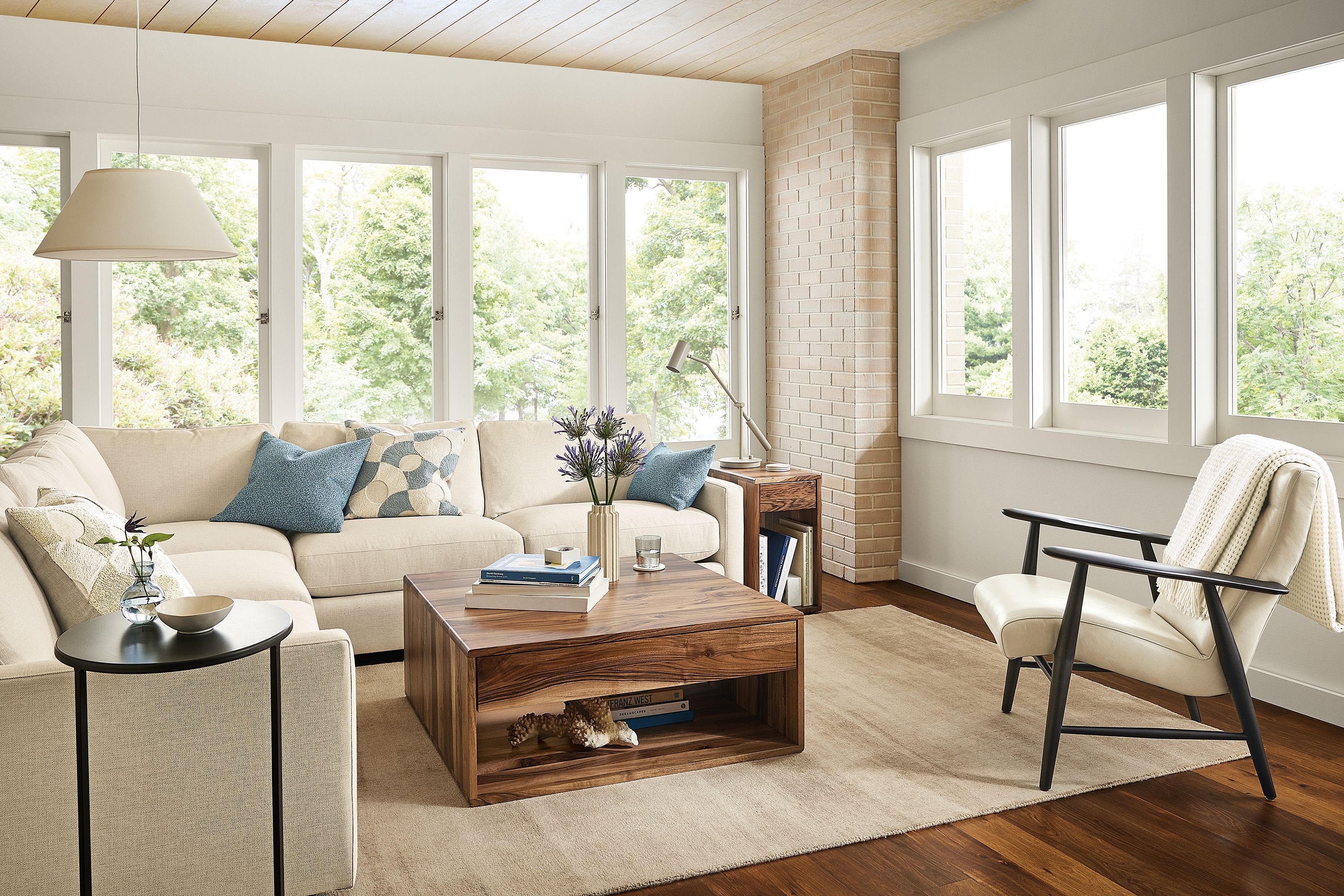 Living room with Linger sectional, Jonas chair, Graft coffee table, Impression rug.