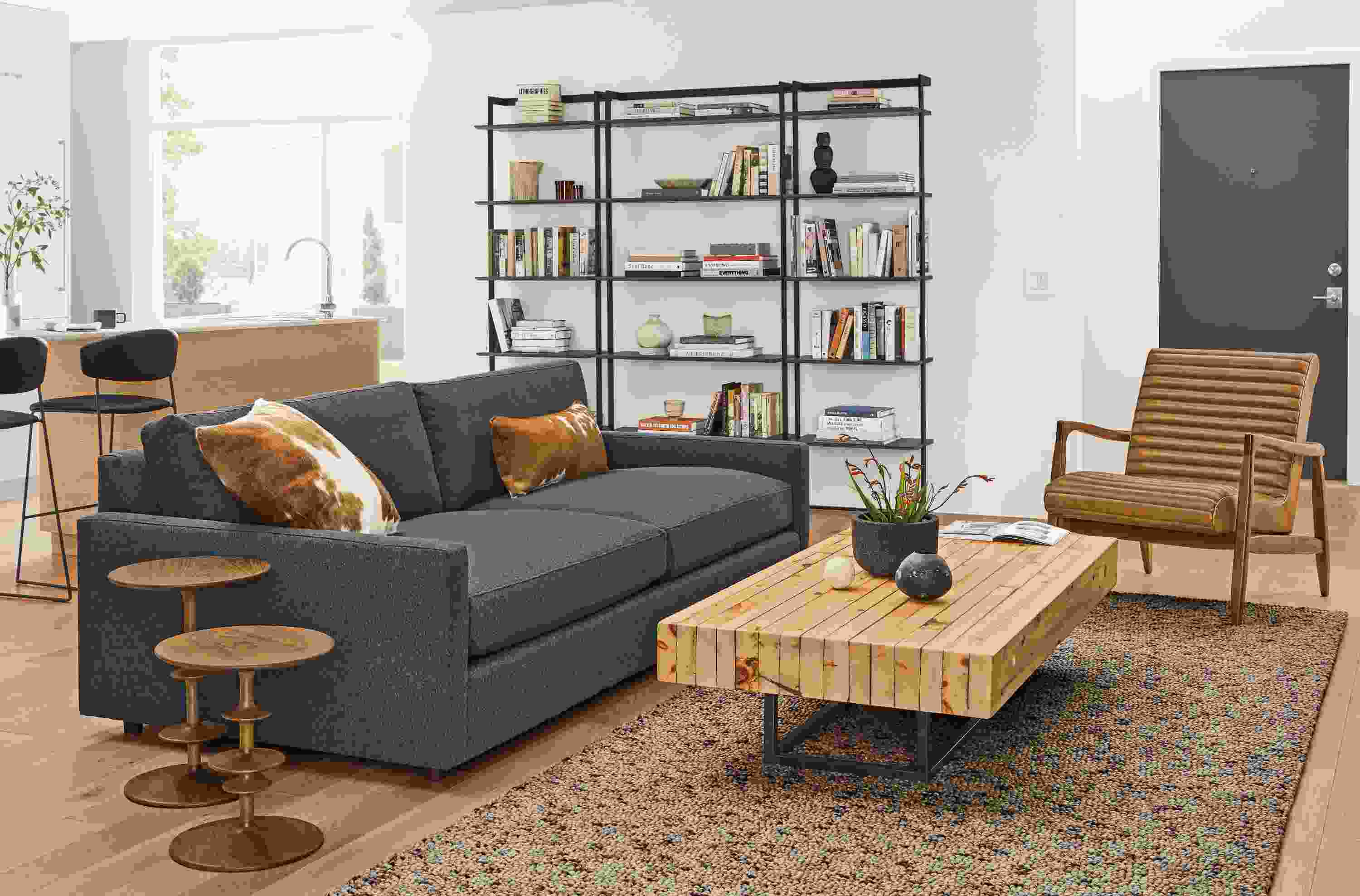 Detail of Linger grey sofa in warm living room.