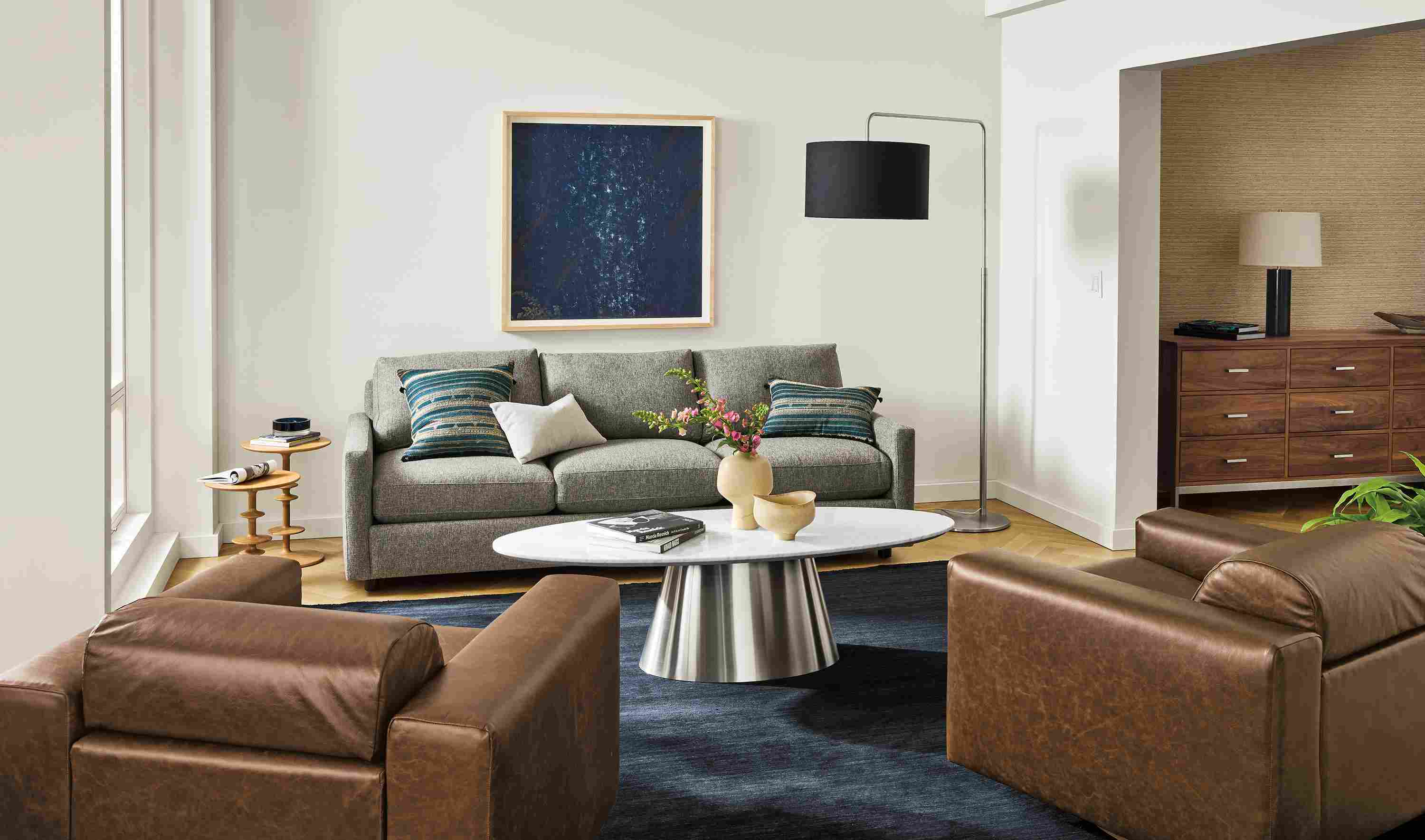 Living room with Linger sofa in Tepic Grey, 2 Harmon swivel chair in Palermo Bourbon leather and 2 Parks end tables.