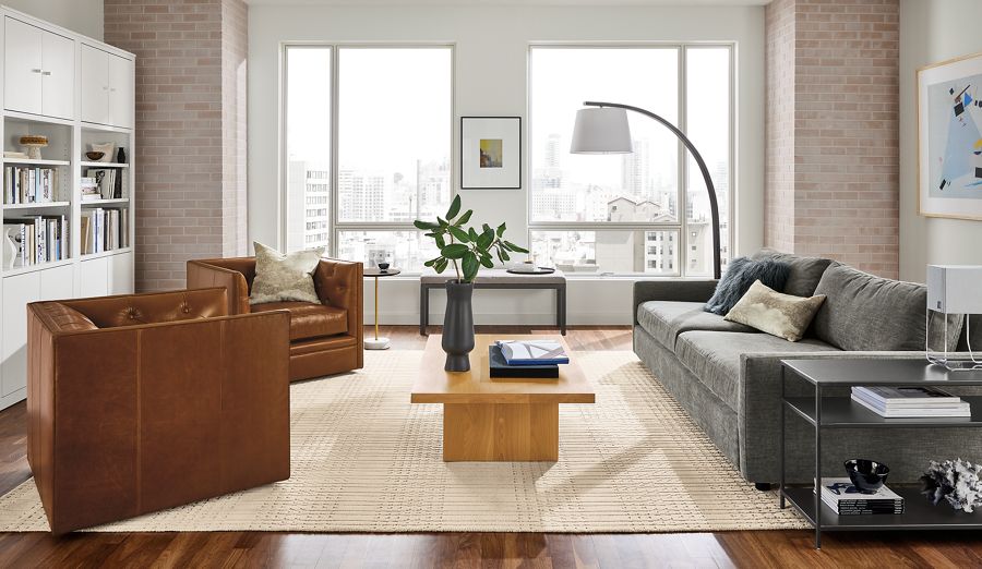 Living room with 91-wide Linger deep sofa in mori fabric, macalester swivel chairs in vento leather.