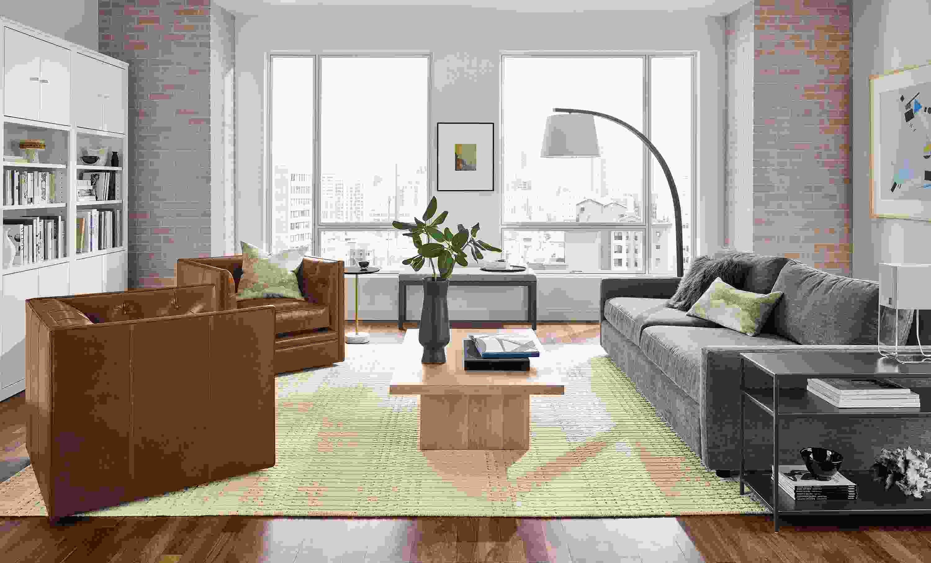 Living room with 91-wide Linger deep sofa in mori graphite, Macalester swivel chairs in vento cognac leather.