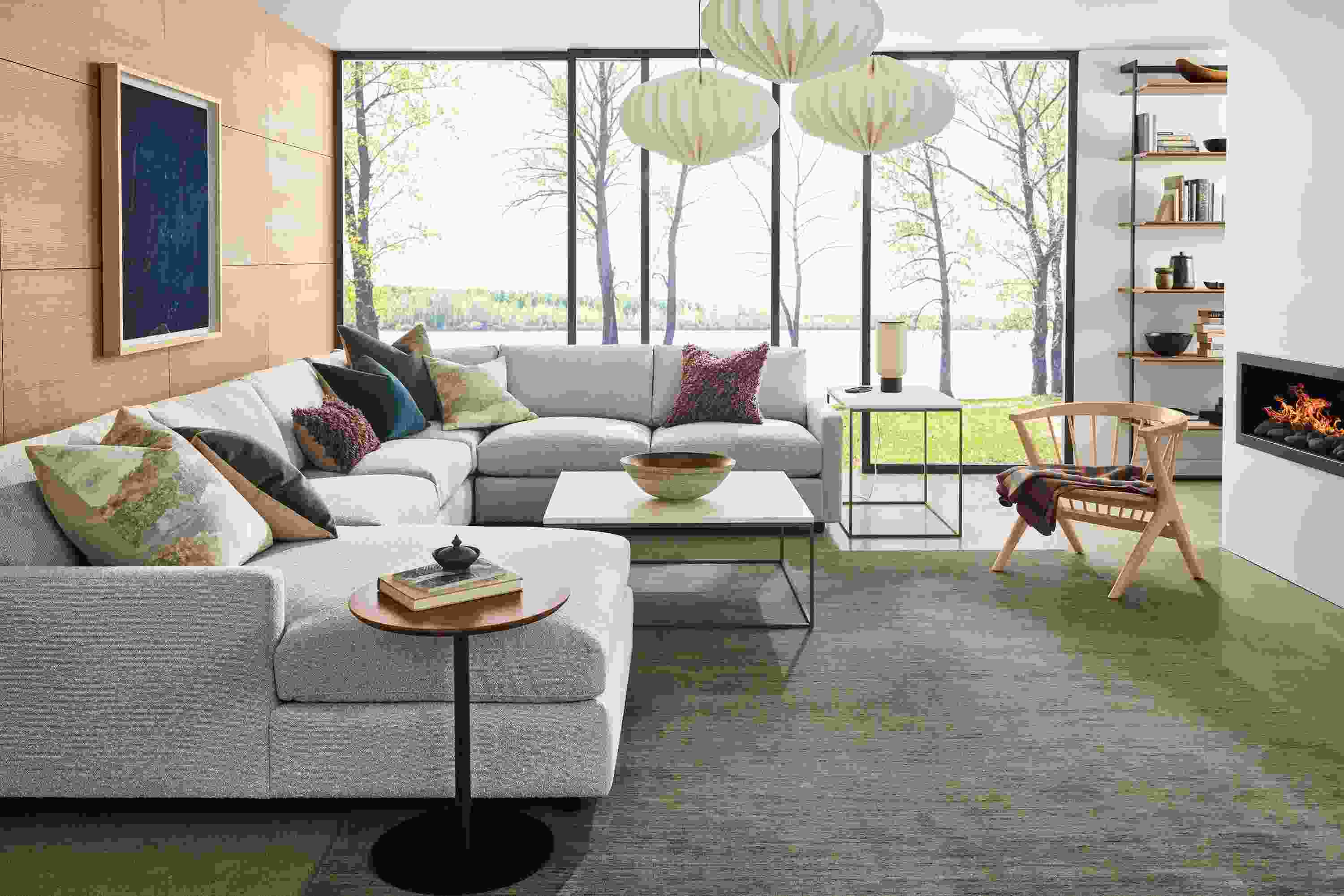 Living room with Linger 4-piece sectional sofa in Declan Natural, Nomad rug in olive and Tyne coffee and end tables.