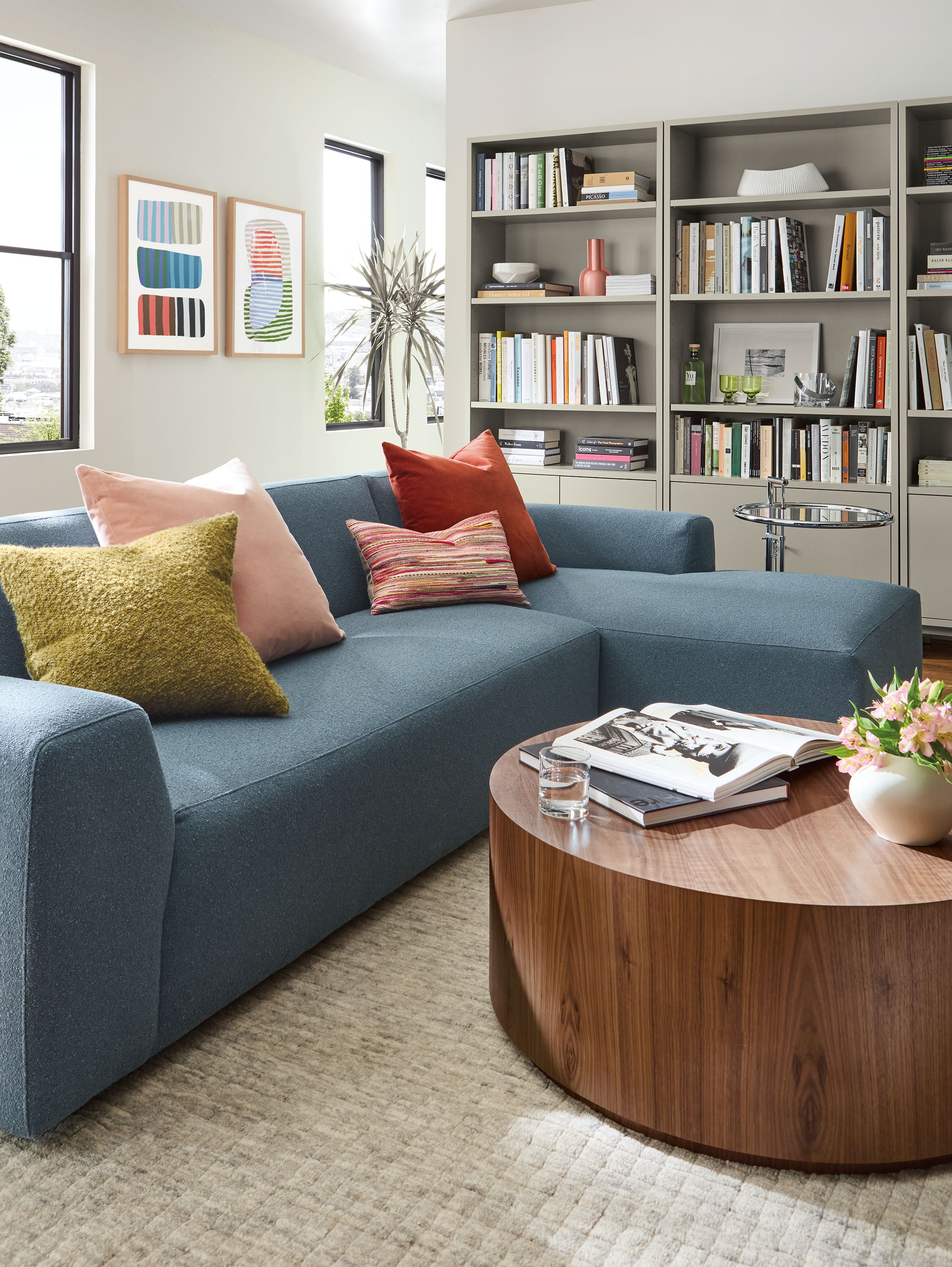 Living room with Linville sofa in Declan Ocean, Liam coffee table in walnut ane Eileen Gray table in chrome.