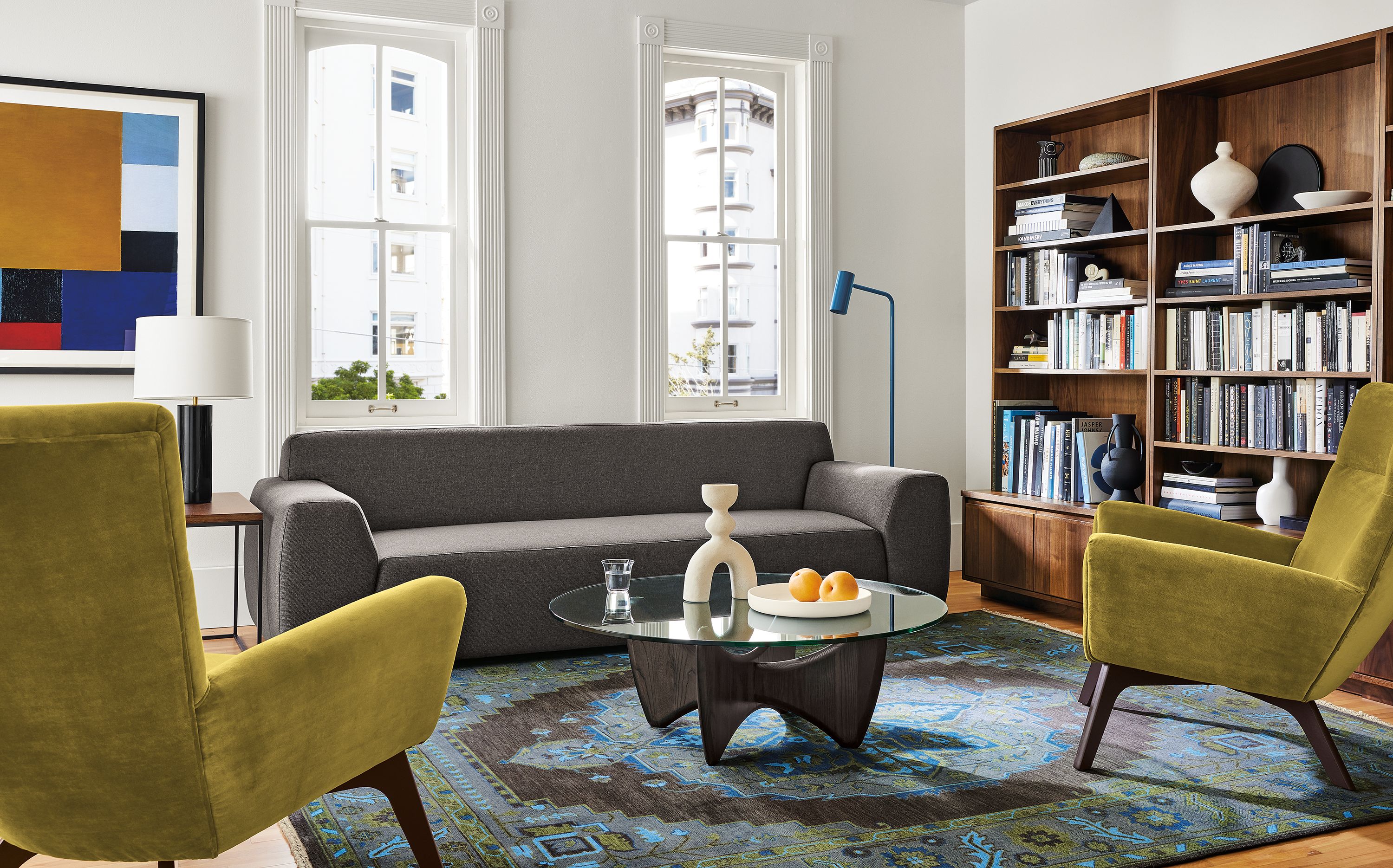 Living area with Linville sofa in Gino charcoal fabric, two Boden chairs in Vance mustard, Sanders coffee table and Heriz rug in ink.