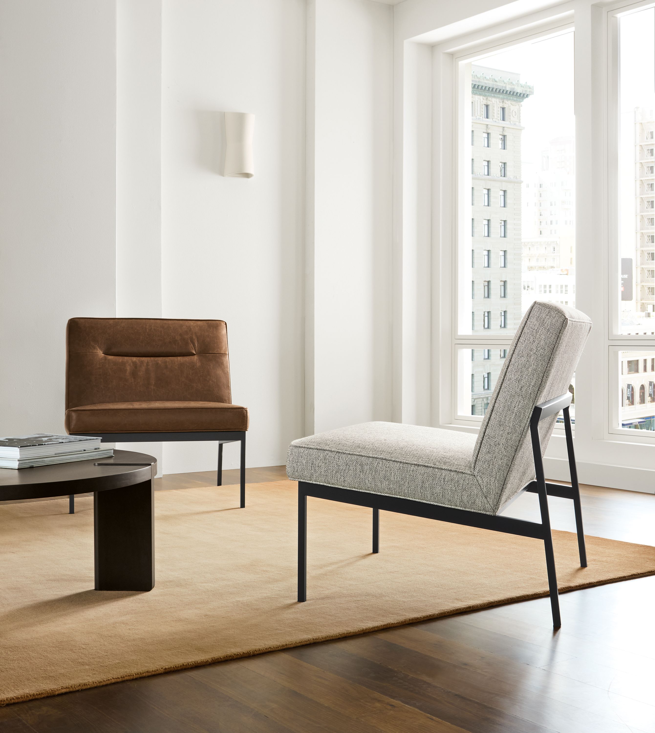 Seating area with Lisbon chair in Tepic Cement, and one in Palermo Bourbon leather.