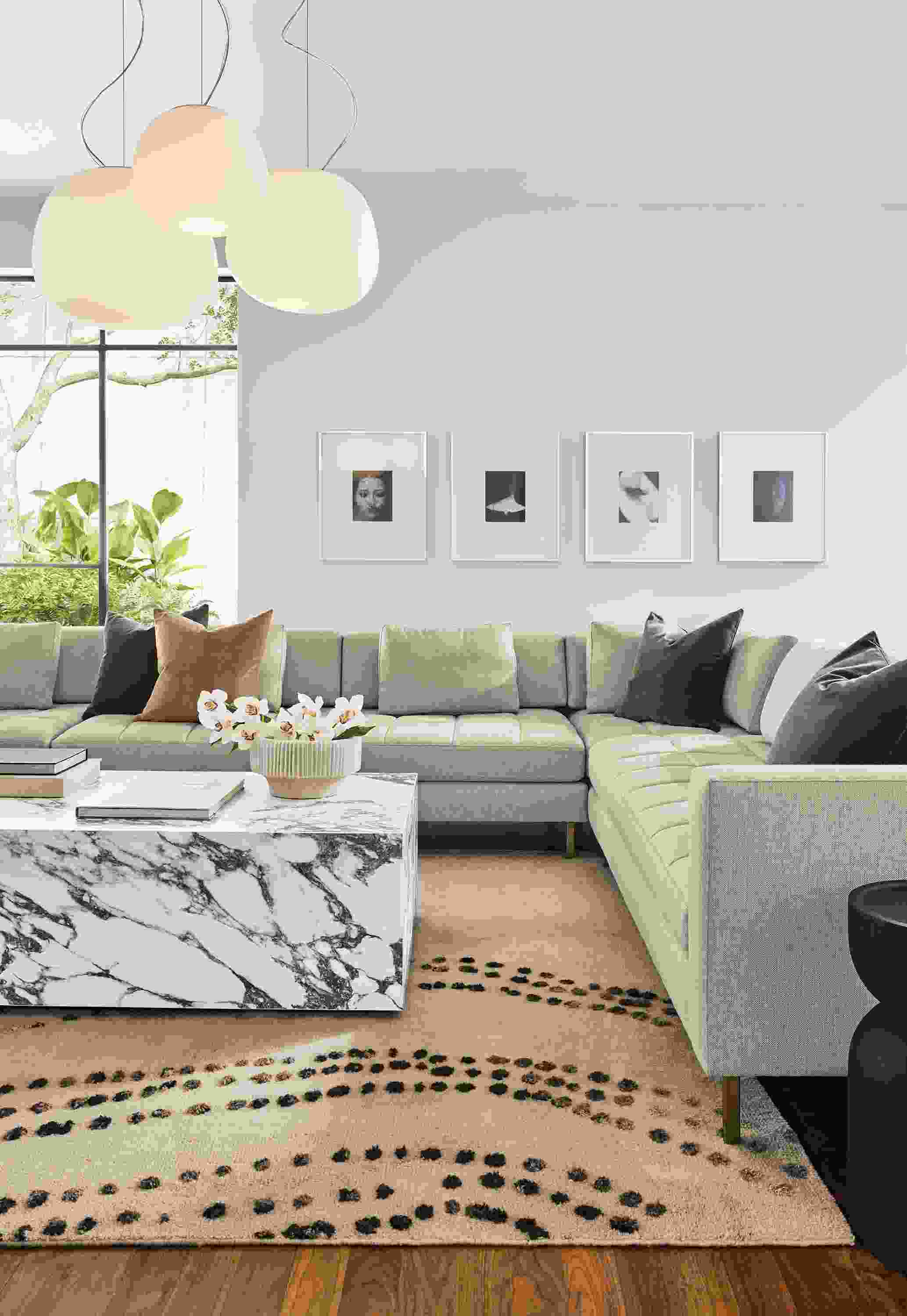 Living room with Lloyd sectional in Sumner Linen and Leona coffee table in marbled white and charcoal ceramic.
