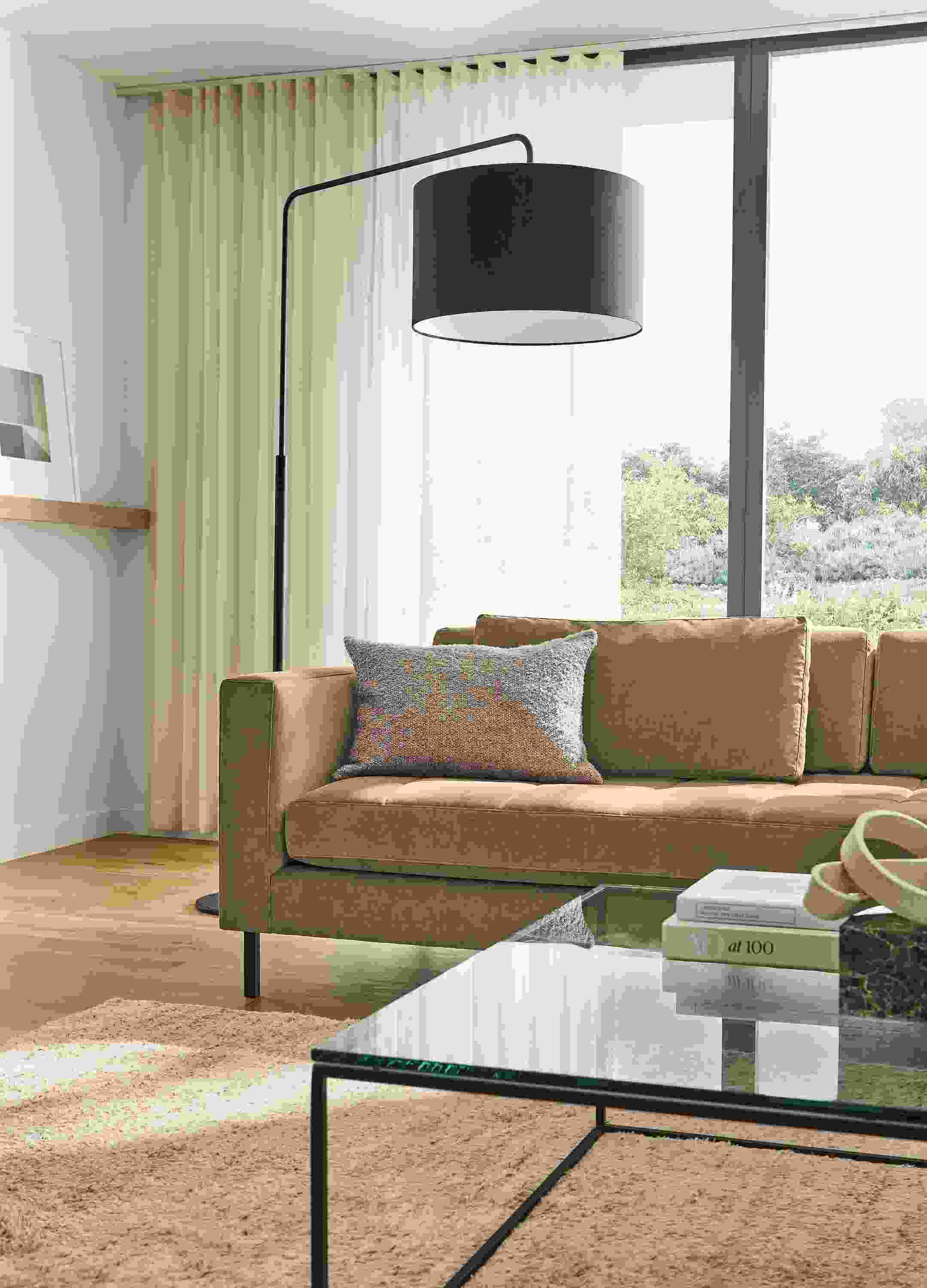 Living room with Lloyd 92-wide sofa in Windsor Otter, Tyne coffee table in clear glass and graphite and Kalindi rug in Flax.