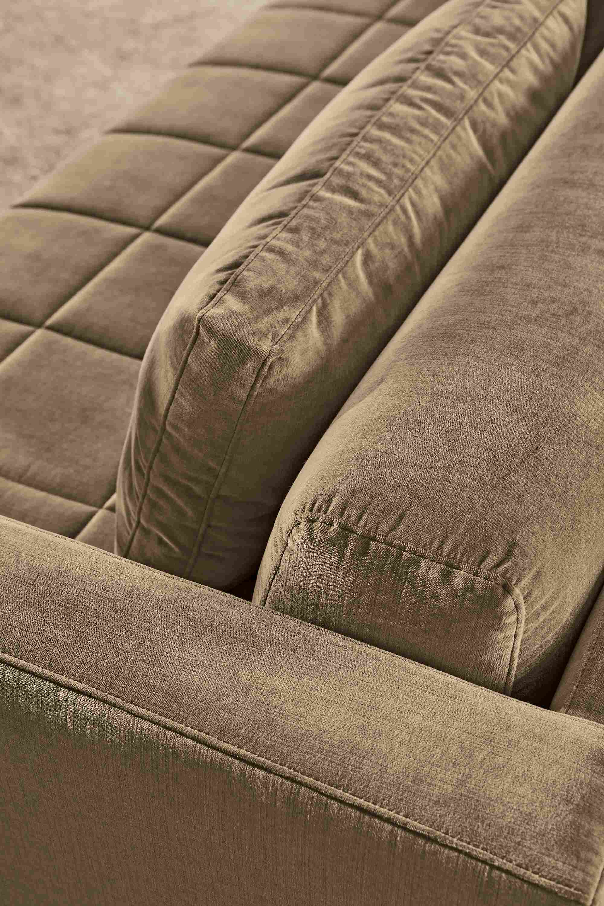 High-angle detail of cushions on a Lloyd 92-wide bench cushion sofa in Windsor Otter and Kalindi 8 by 10 rug in flax.