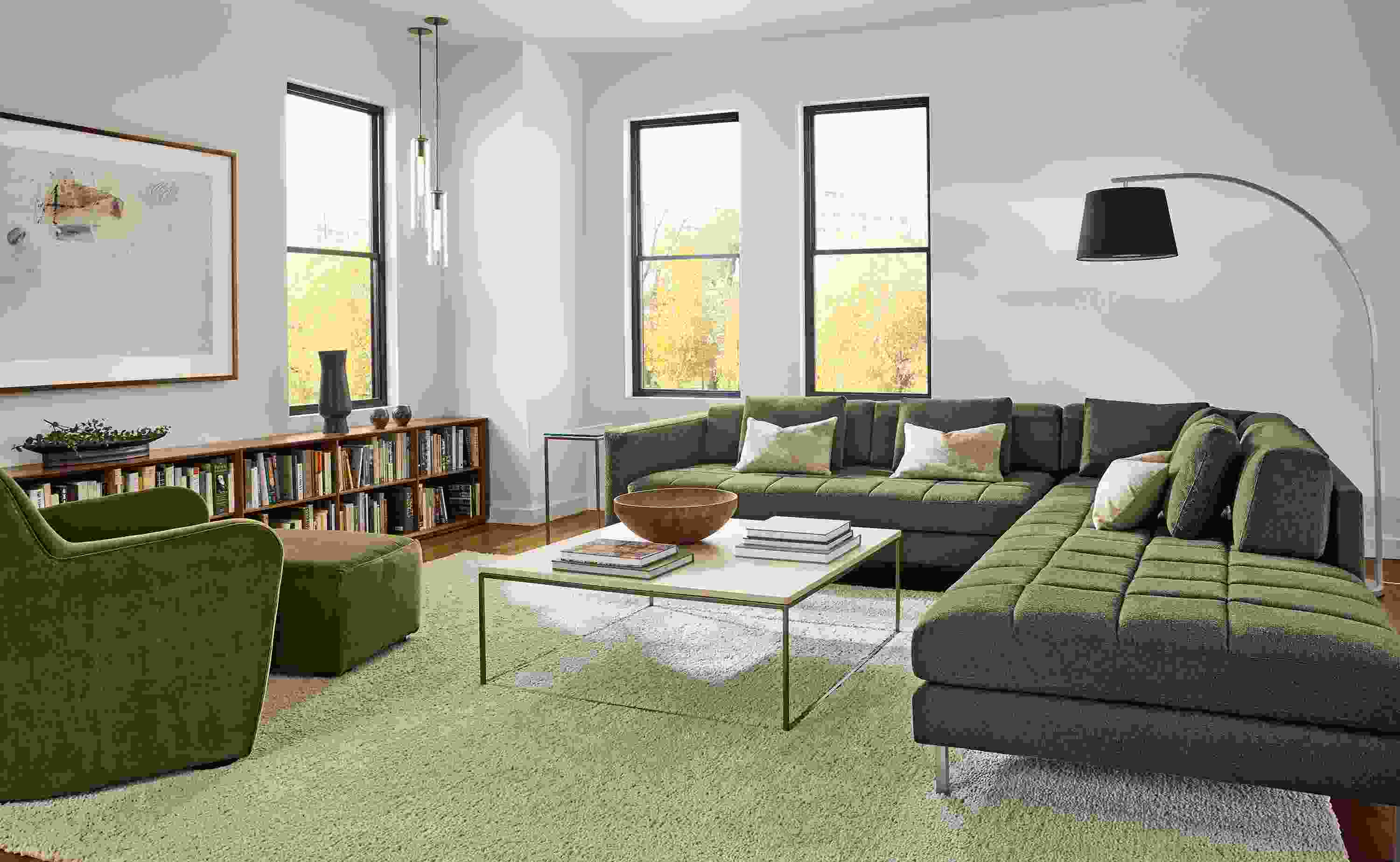 Living room with Lloyd 120 by 114 sectional sofa in declan olive, Lily chair and ottoman in redding olive and Arden rug in oatmeal.