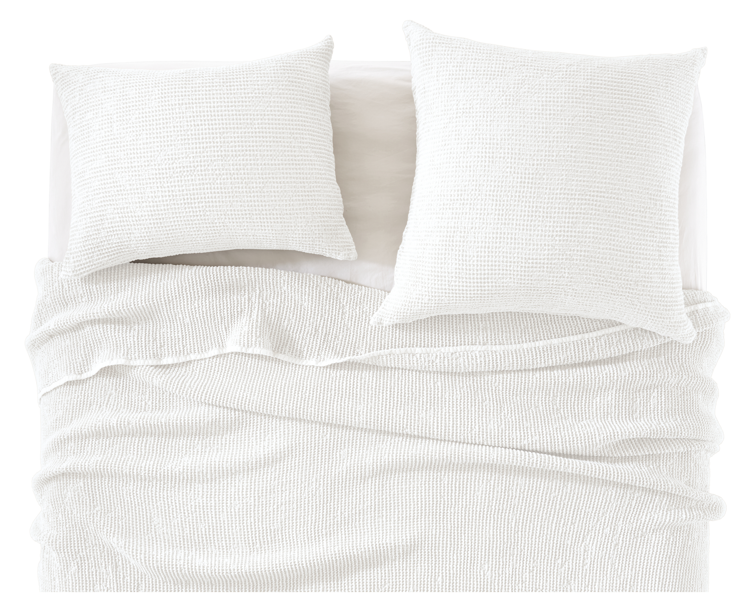 detail of loren coverlet and shams in white on bed.