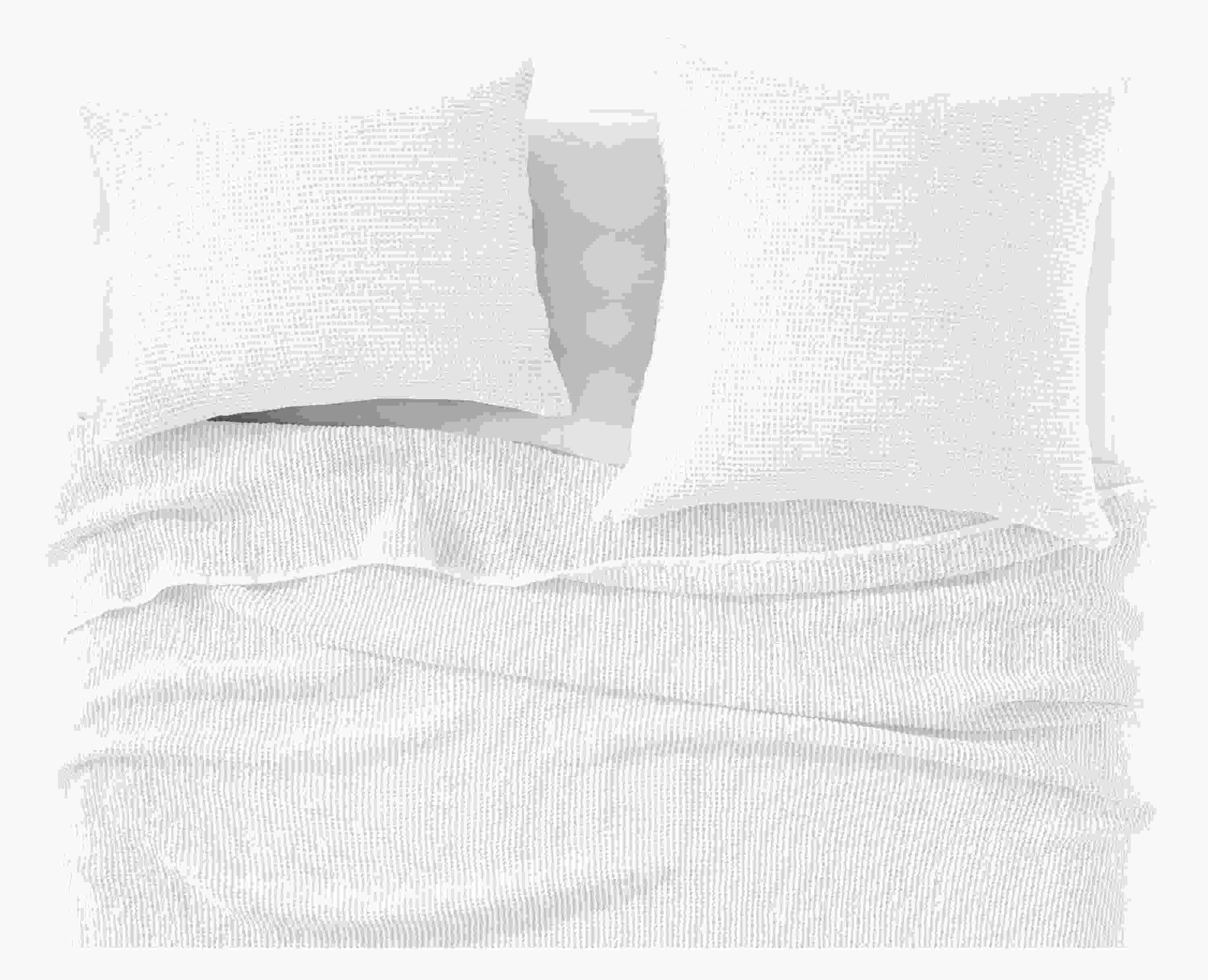 detail of loren coverlet and shams in white on bed.