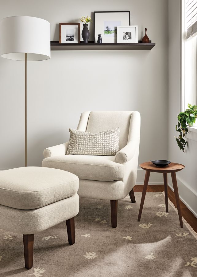 living room with Louise Chair and ottoman in Tepic Ivory, fremont floor lamp.