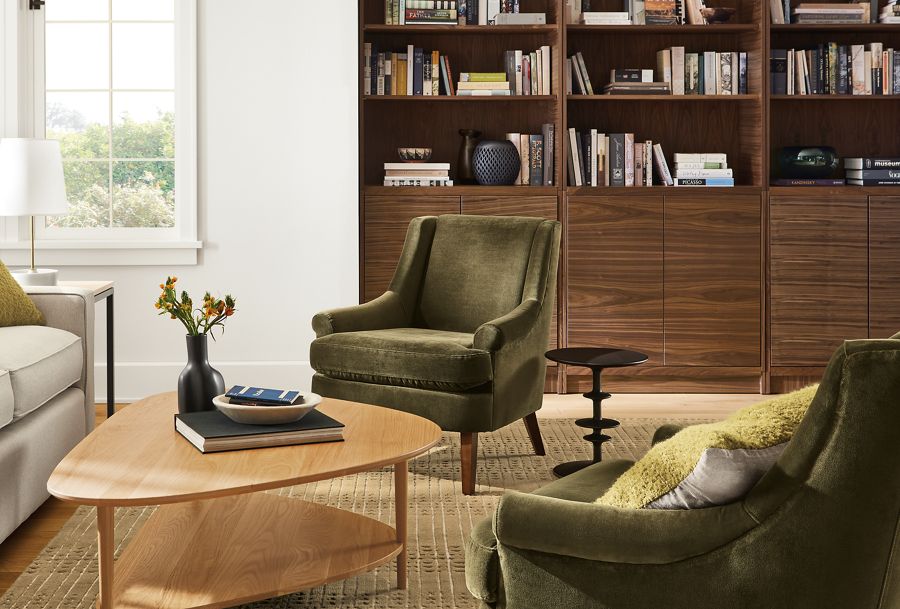 Living room with Louise chairs in Vance olive, gibson talbe in white oak and Taylor bookcases in walnut.