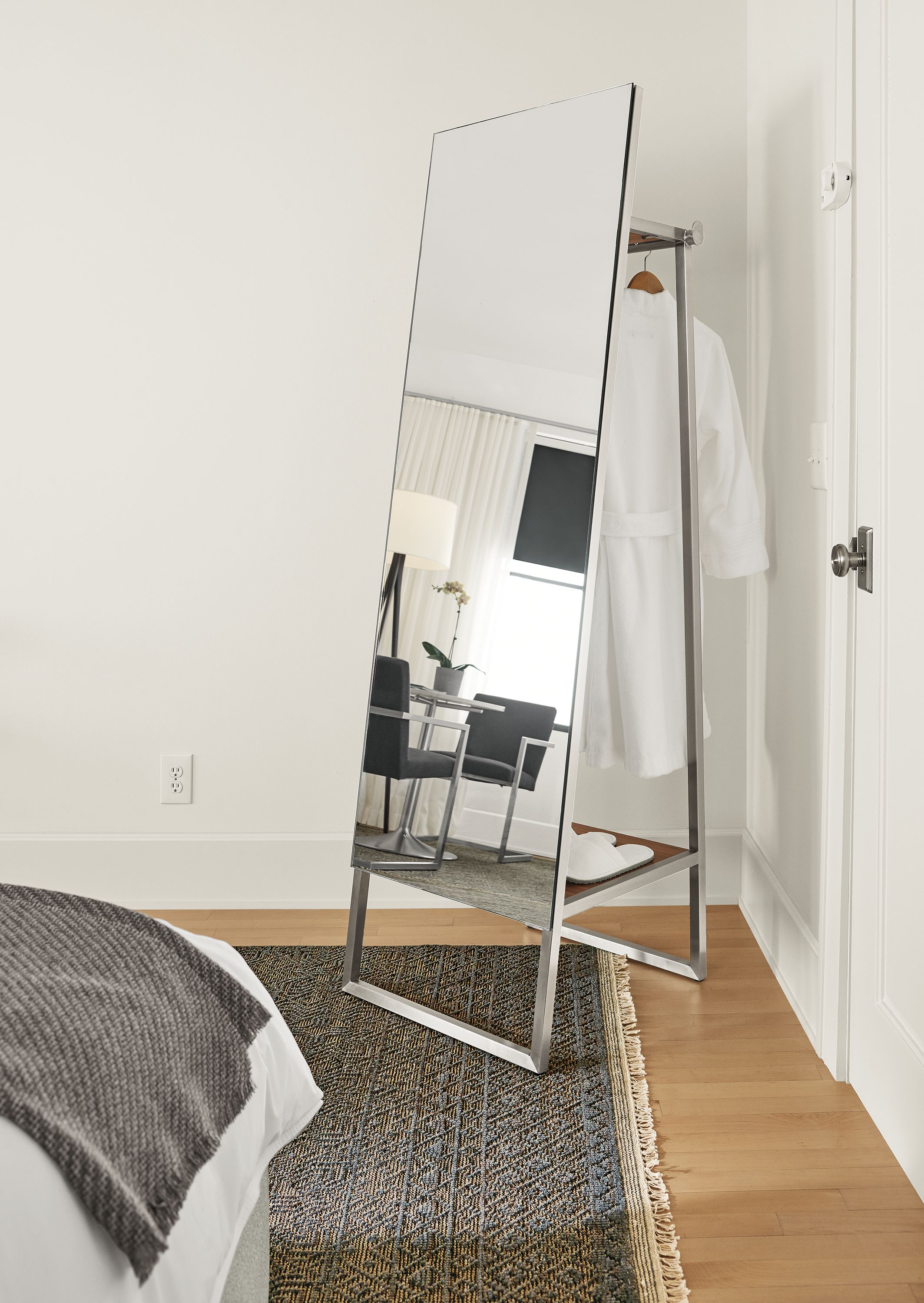 Detail of Lydia wardrobe mirror in stainless steel and walnut.