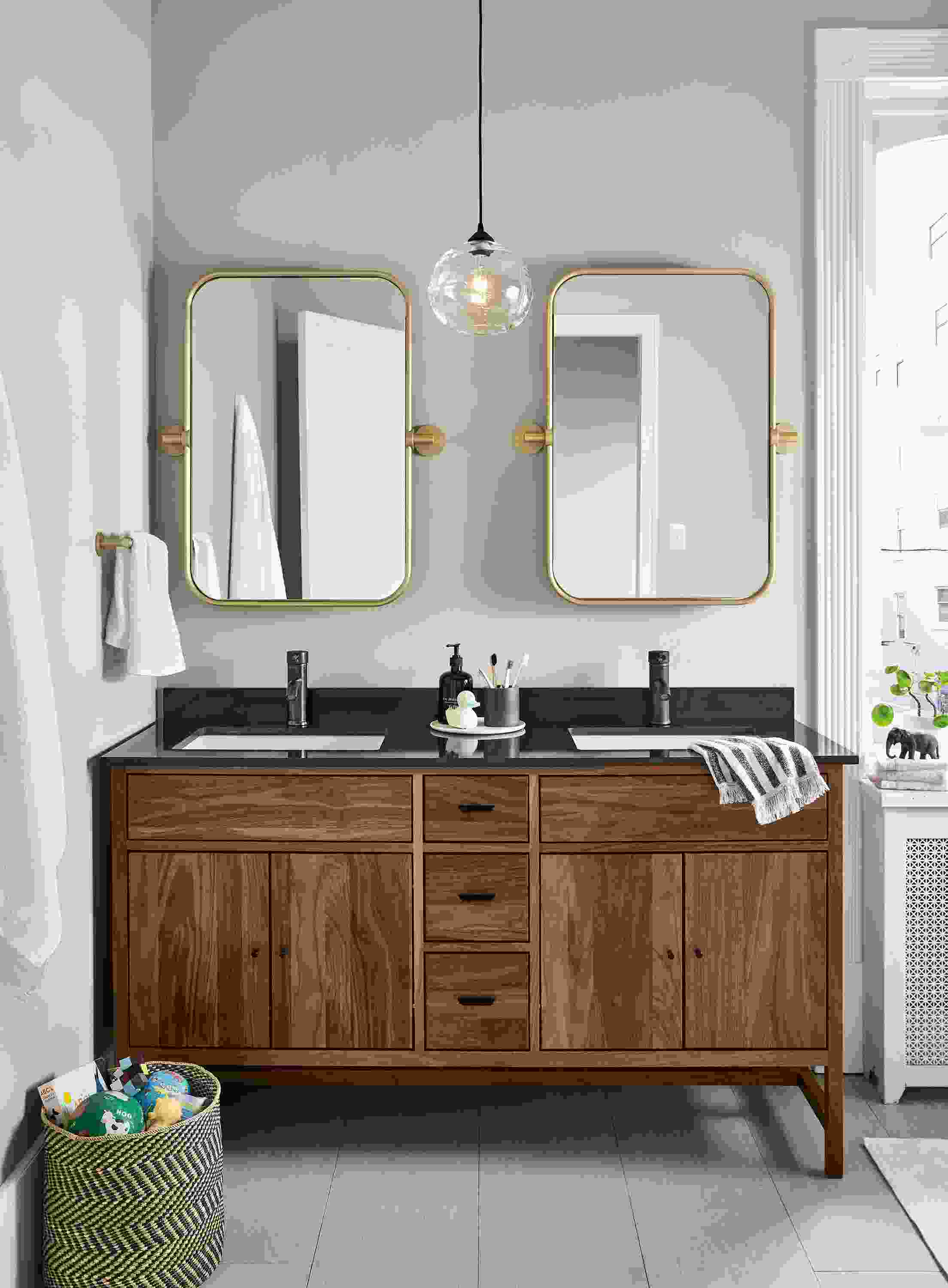 Bathroom with 2 Lyndale wall mirrors in brushed gold powdercoat over a Berkeley vanity in walnut.