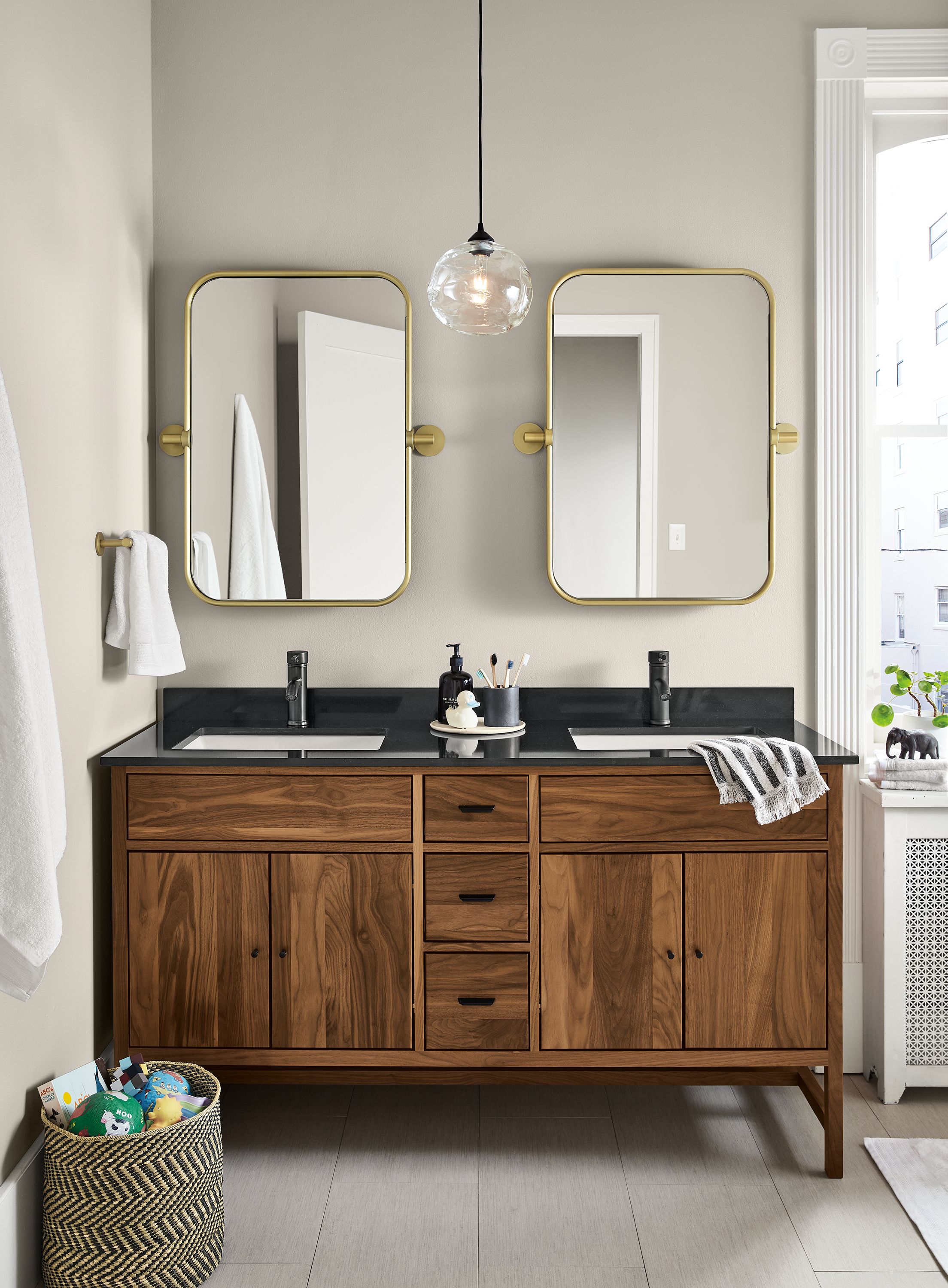 Bathroom with 2 Lyndale wall mirrors in brushed gold powdercoat over a Berkeley vanity in walnut.