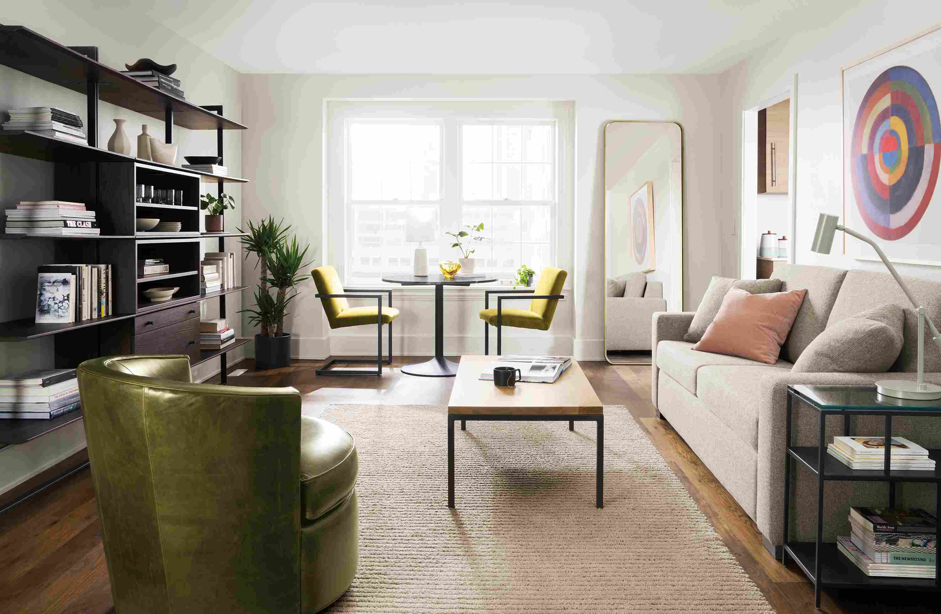 Living room including Lyndale floor mirror in brushed gold powdercoat and Metro sleeper sofa in tatum grey.