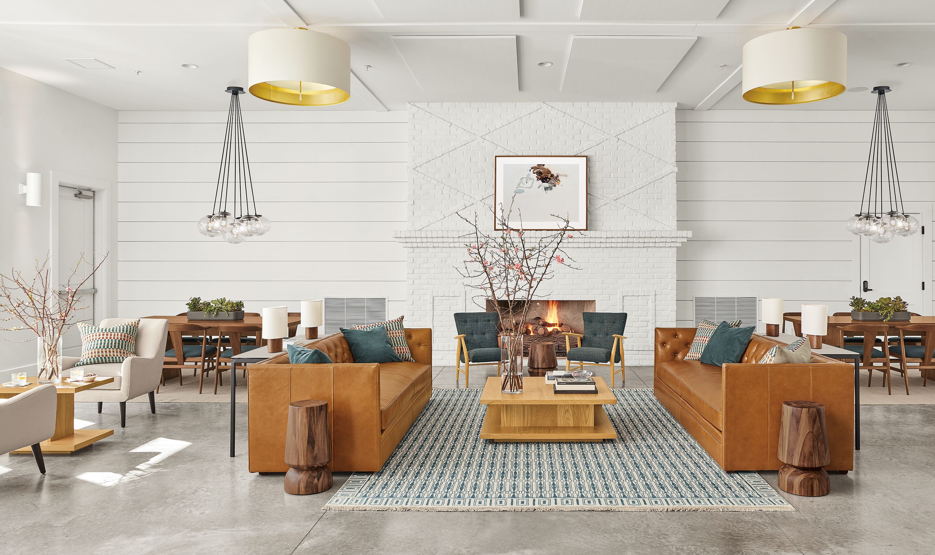 Detail of Macalester sofas (2) in Portofino cognac leather in lobby setting.