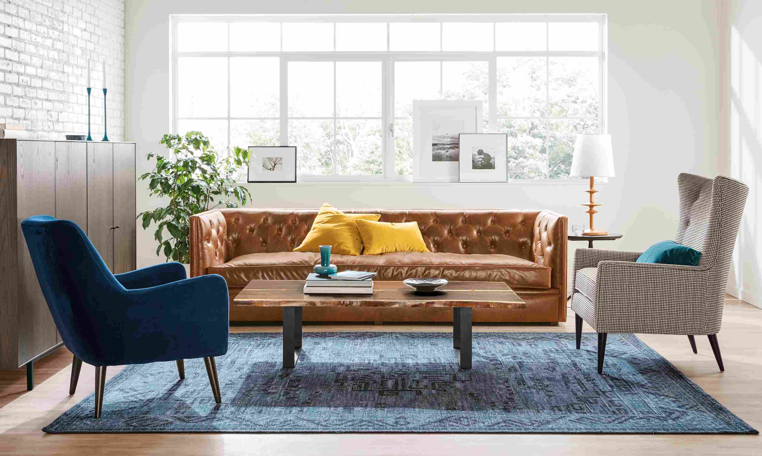 Living room with Macalester 100-inch sofa, Amira rug in indigo and Chilton cocktail table in walnut and natural steel.