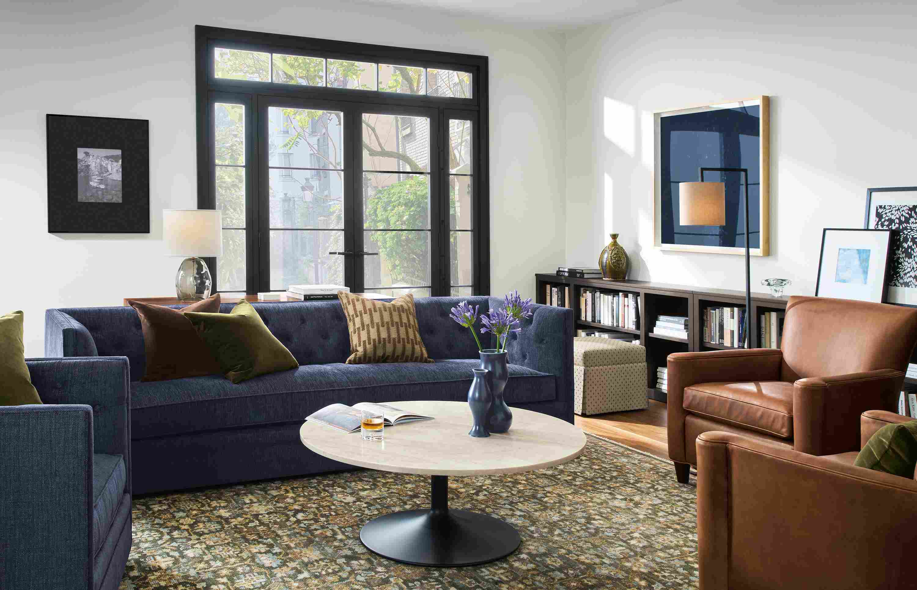 Living room with Macalester sofa and swivel chair in Olmsted Indigo and 2 Savoy chairs in Sarto Cognac.