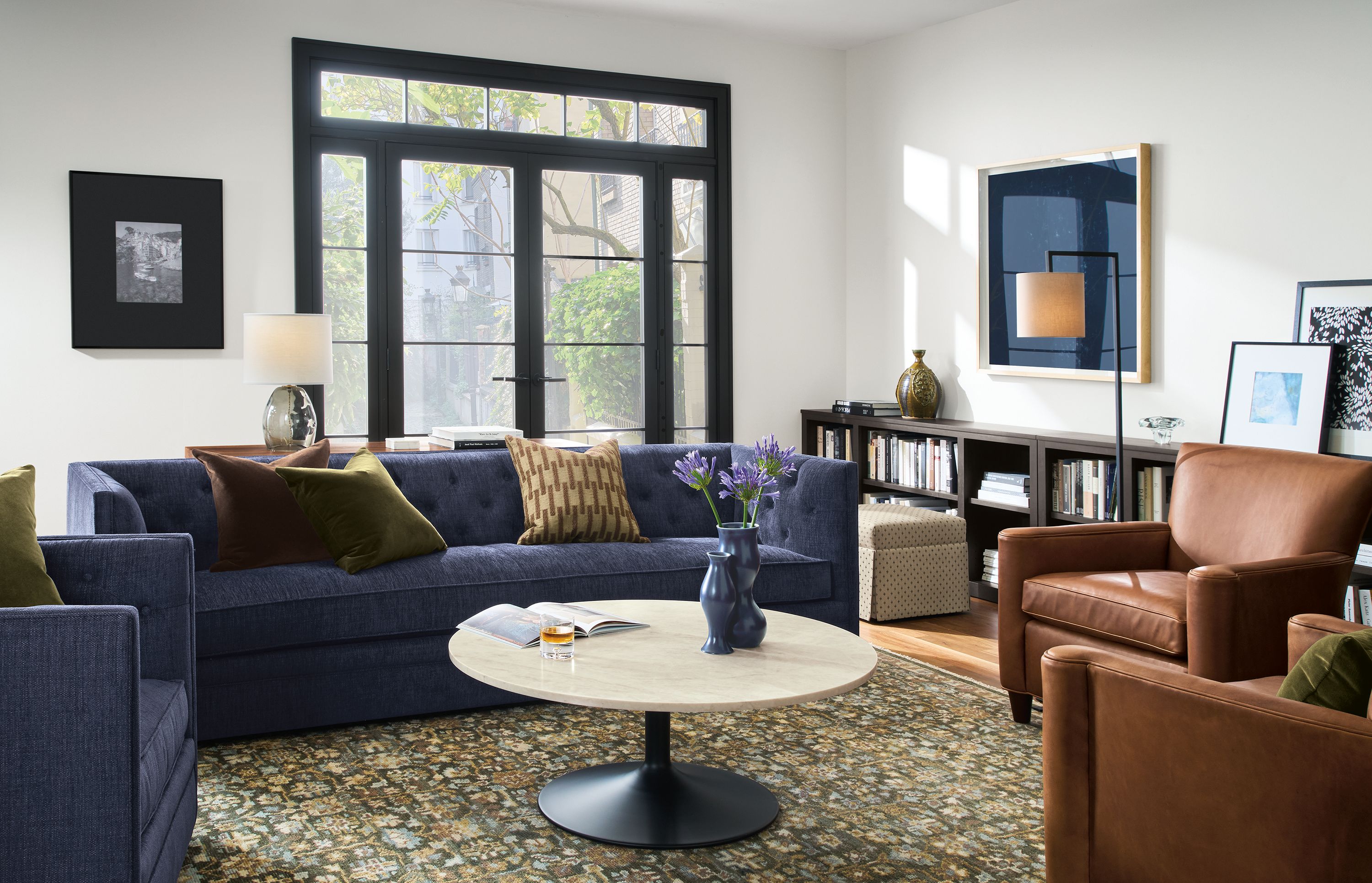 Living room with Macalester sofa and swivel chair in Olmsted Indigo and 2 Savoy chairs in Sarto Cognac.