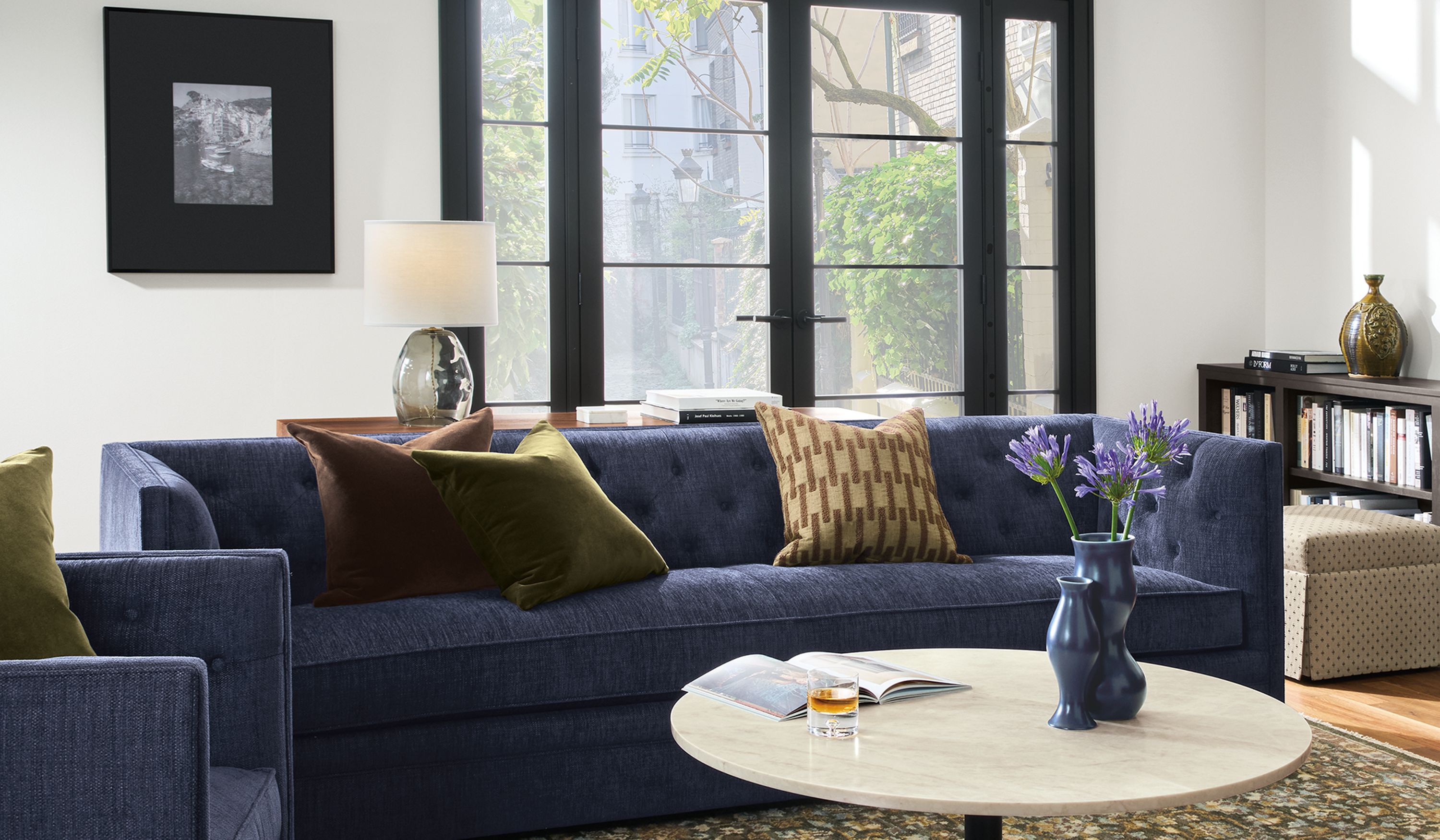 Living room with Macalester sofa and swivel chair in Olmsted Indigo and 2 Savoy chairs in Sarto Cognac.