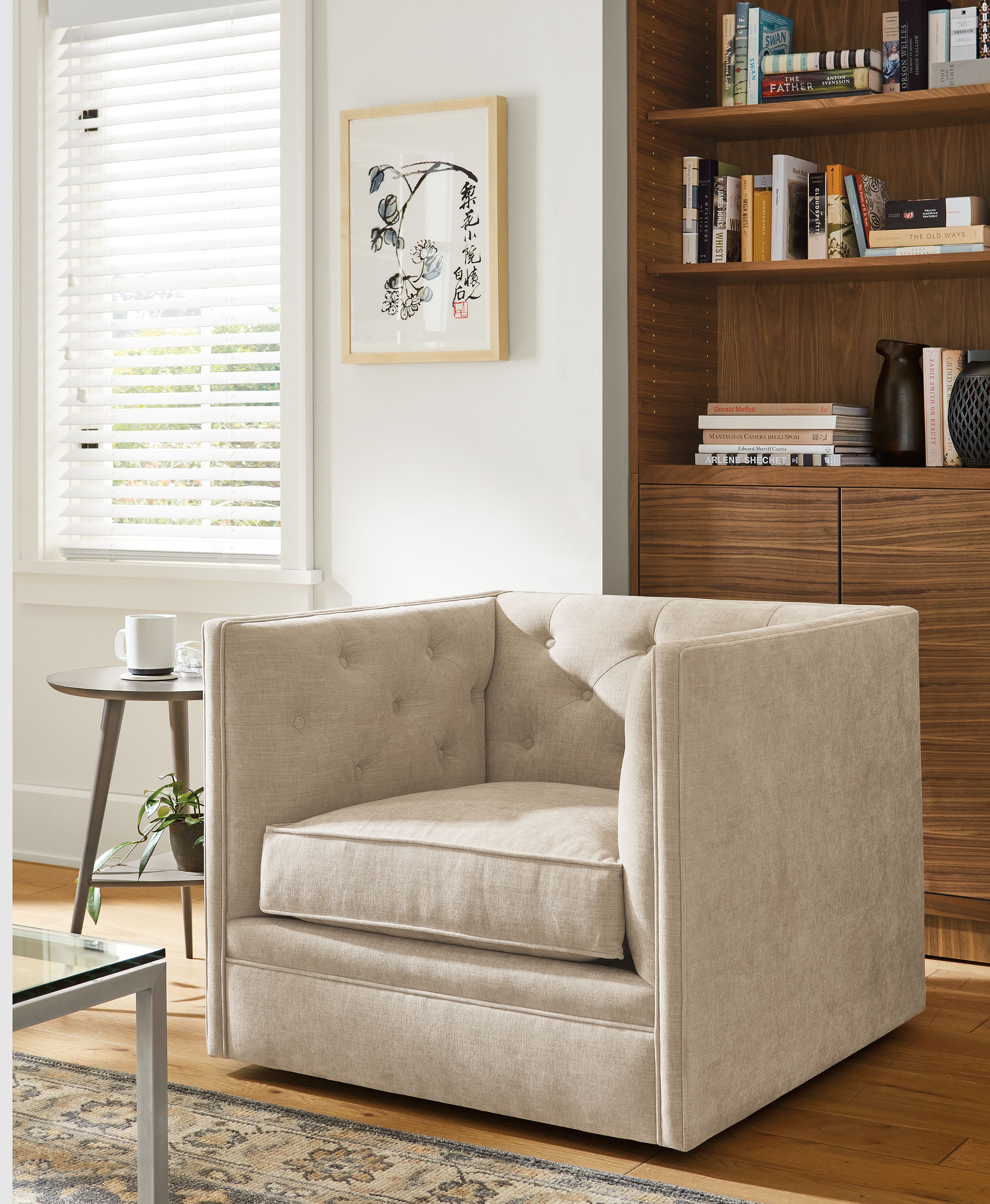 Living room with Macalester swivel chair, Qi Baishi artwork, Taylor bookcase in walnut and Rae end table.