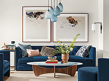 Detail of Macalester sofa in Banks denim fabric in living room with Sanders coffee table and Gabriel Belgeonne wall art.