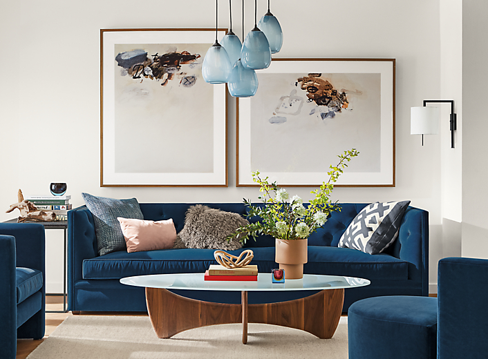 Detail of Macalester sofa in Banks denim fabric in living room with Sanders coffee table and Gabriel Belgeonne wall art.
